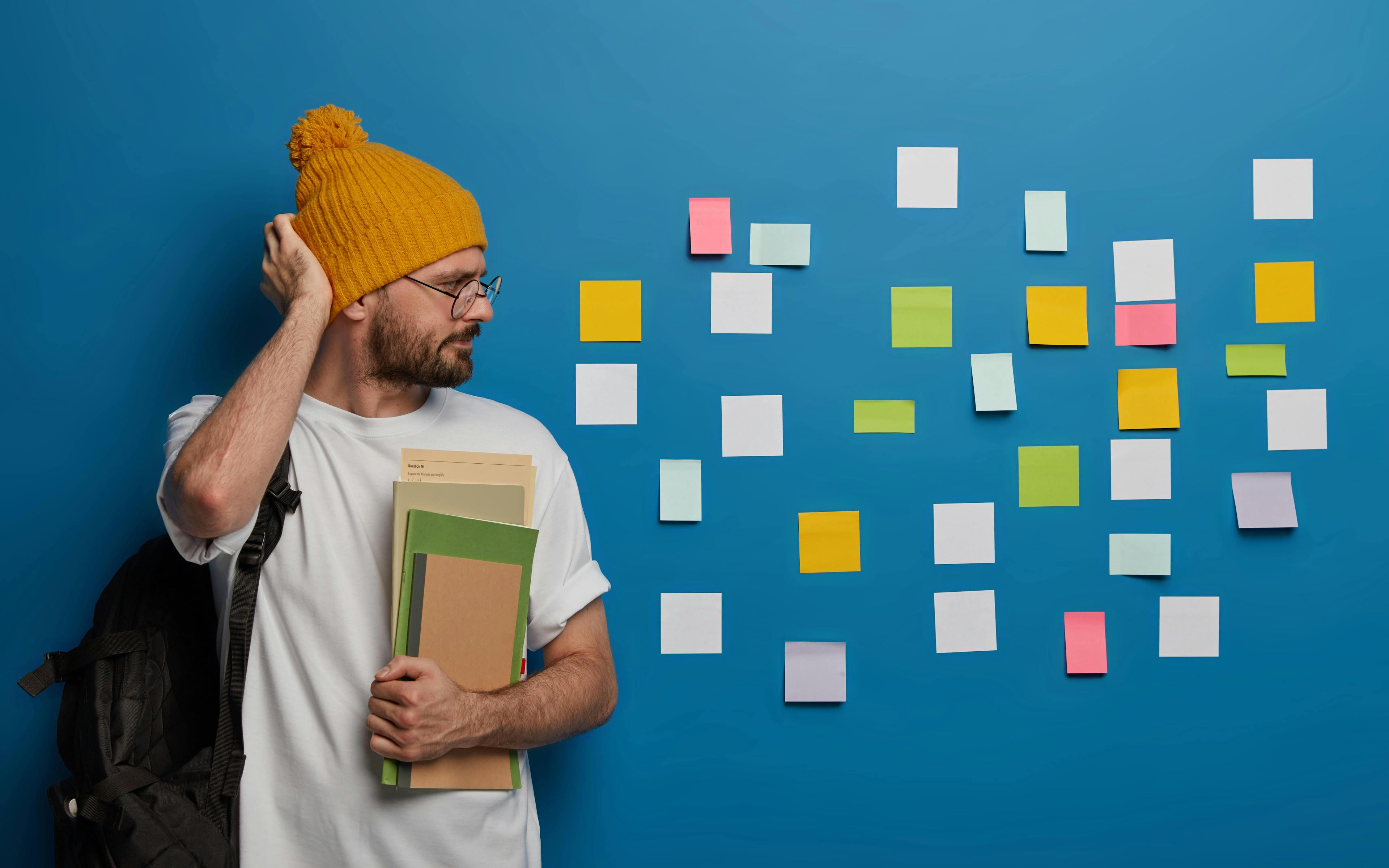 Confused man looking at a bunch of post-it notes