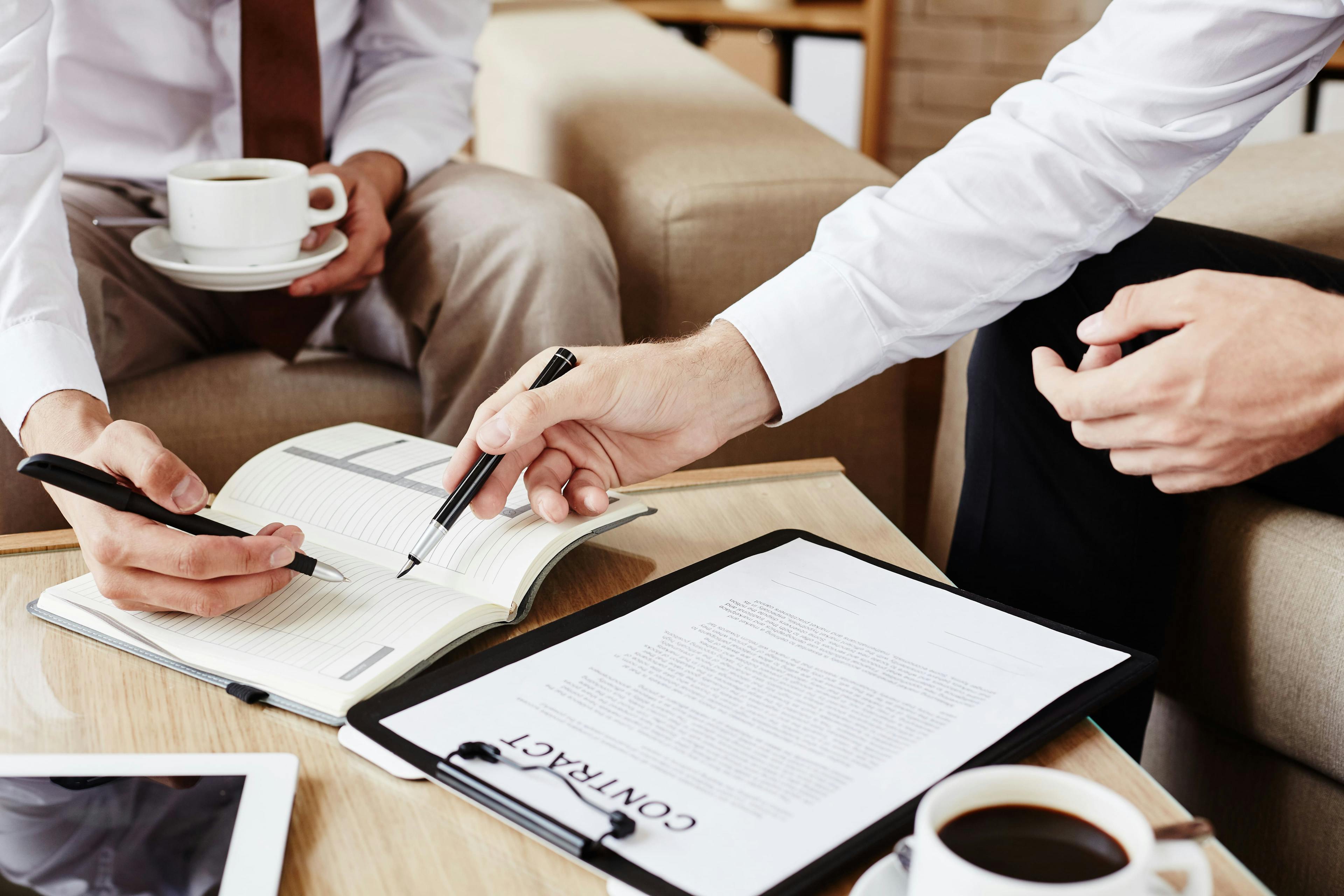 A leasing agent going over the terms of a renter's contract, including fees and deposits.