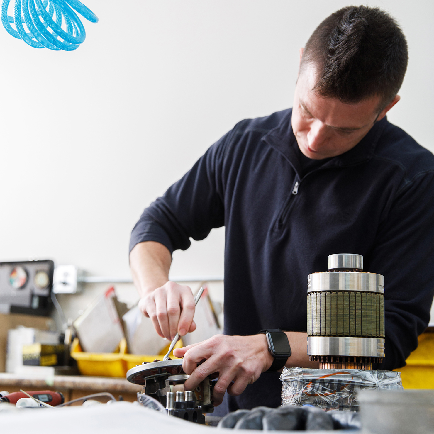 Avionics engineer working on generator parts.