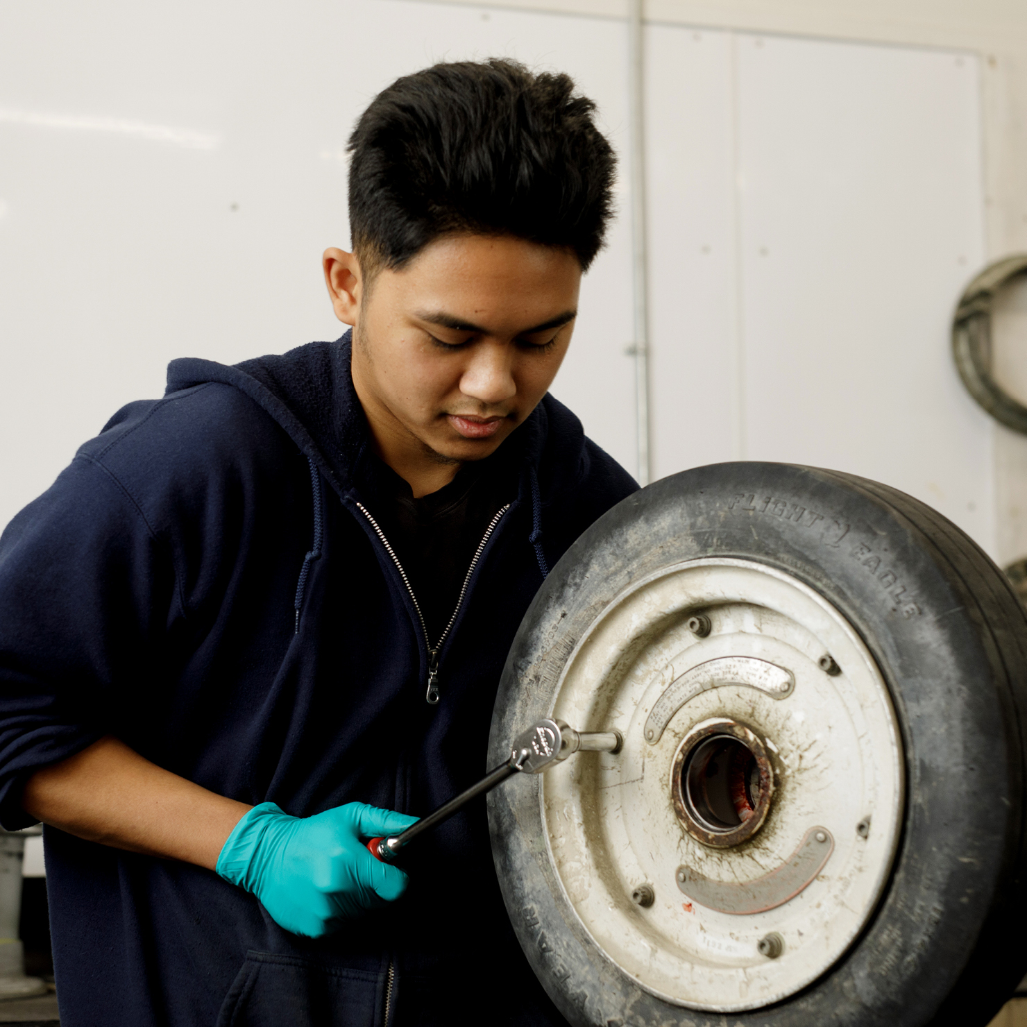 Man working on airplane tire.