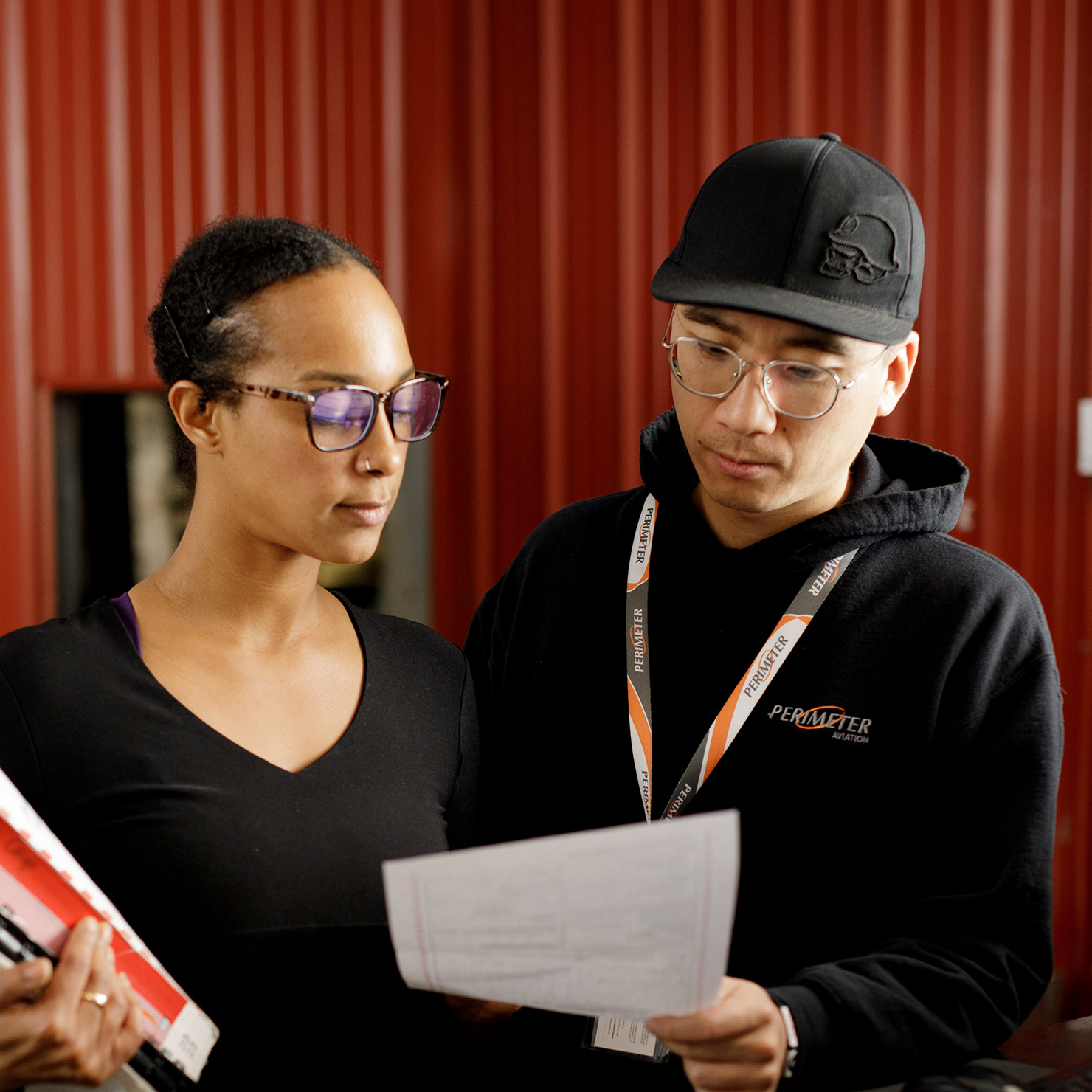 Woman and man looking over document.