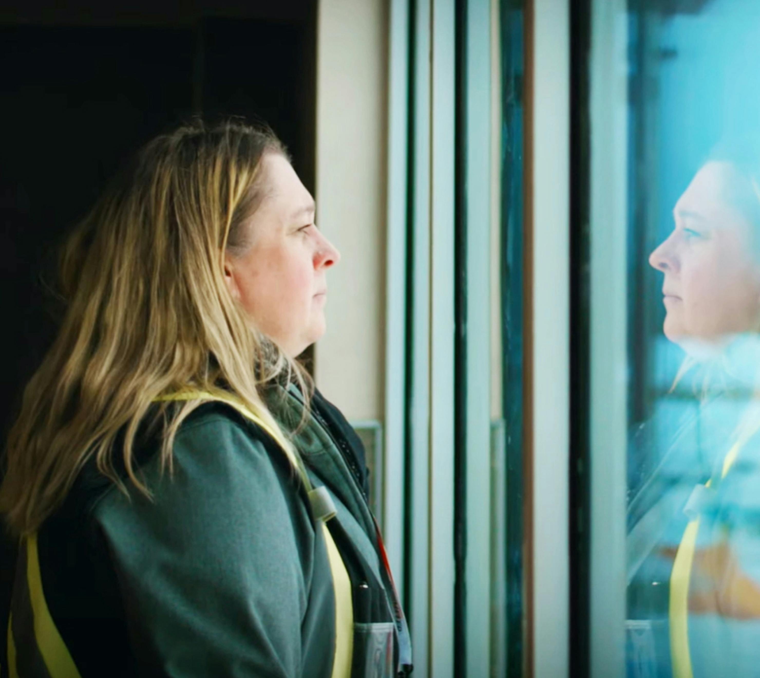 Northern Stations manager looking out a window.