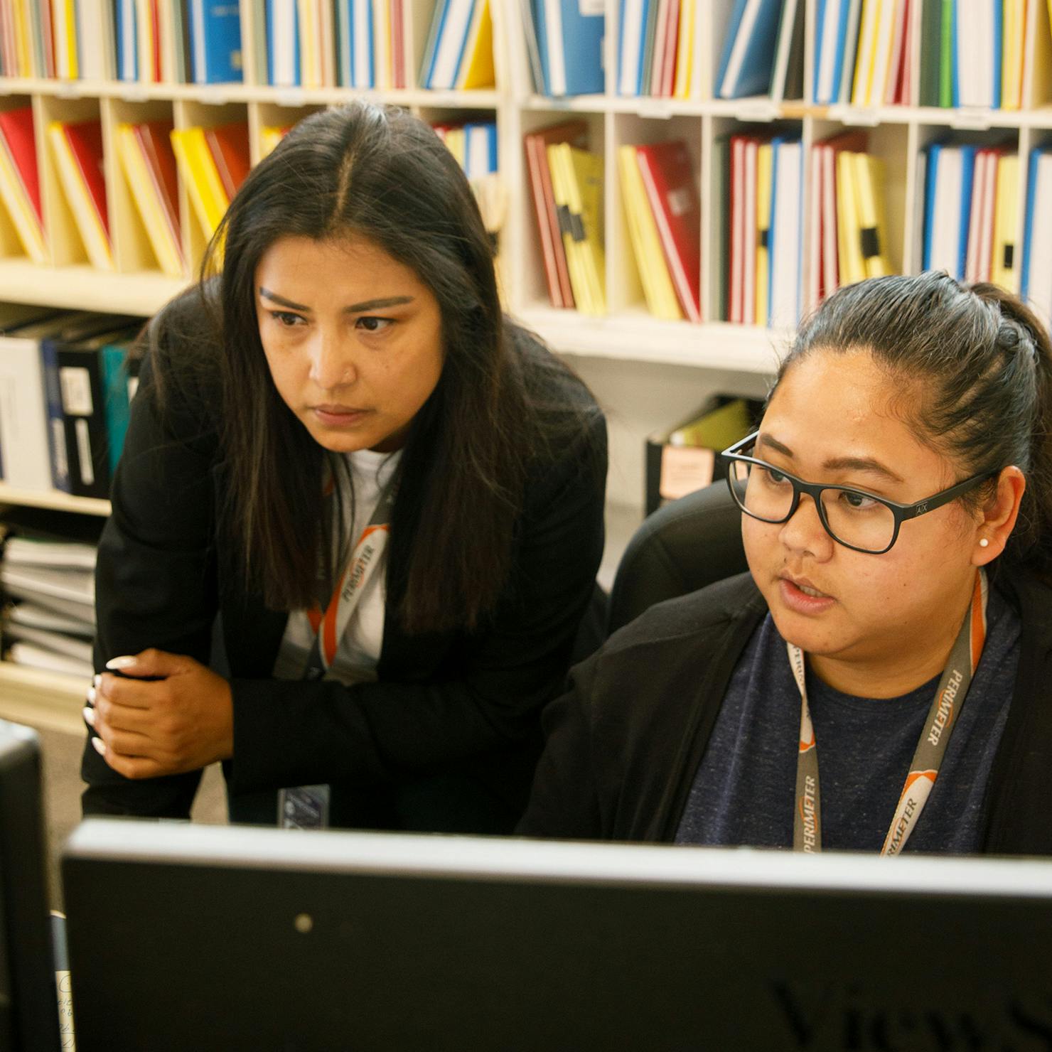Two women looking at computer in Tech Records.