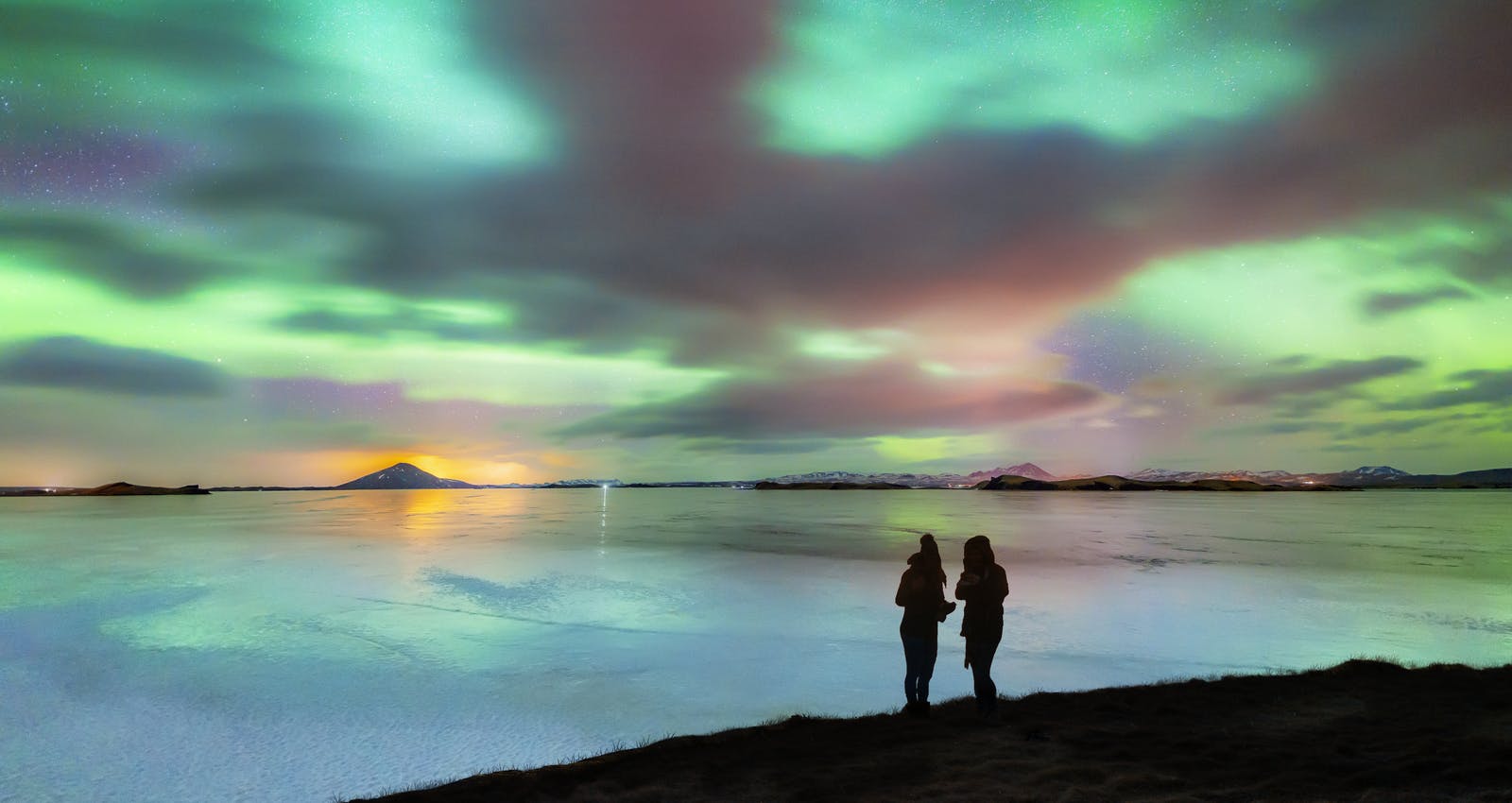 Two people watching the northern lights