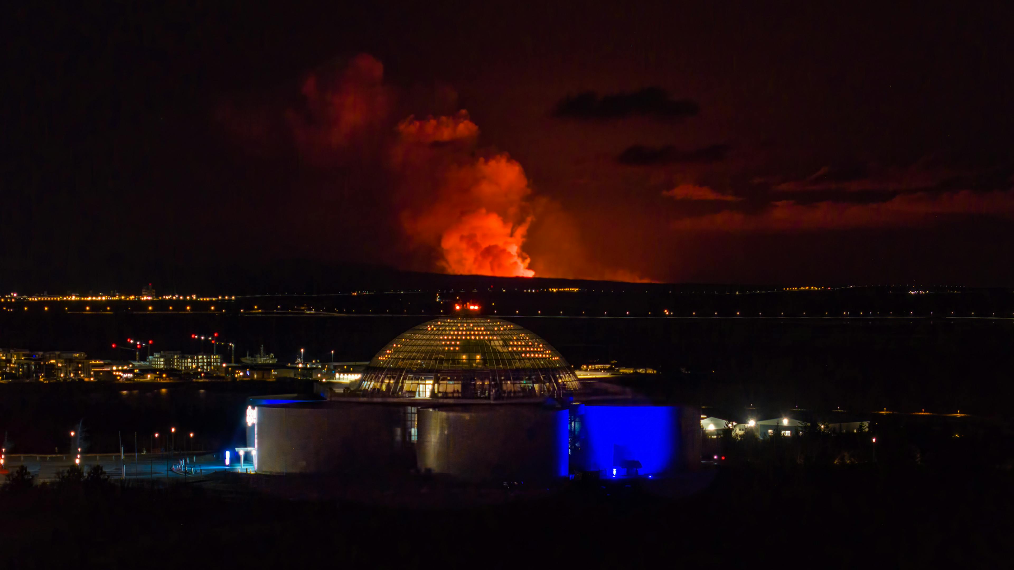 Reykjavik with the volcano eruption in background