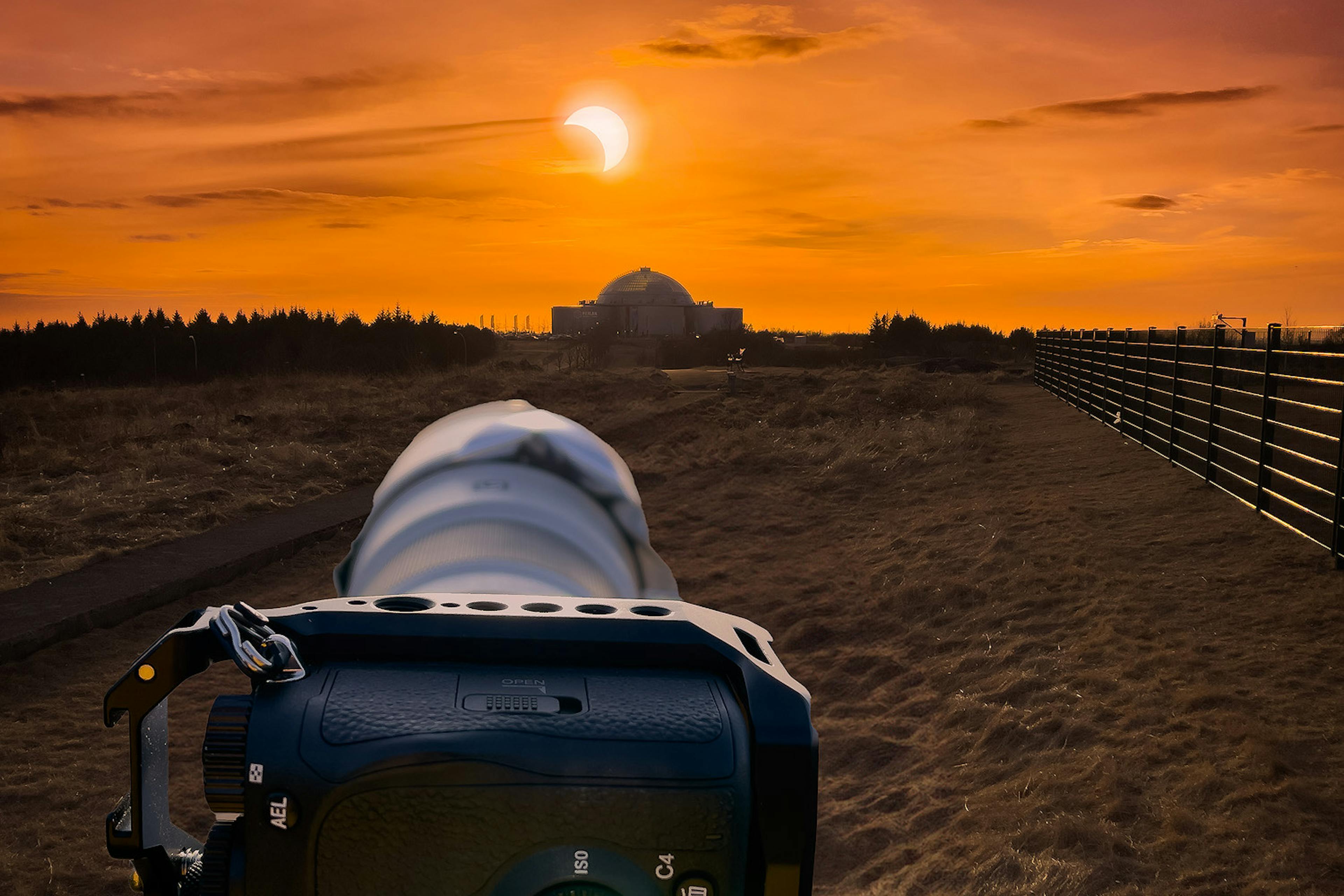 A camera taking a photo of the solar eclipse