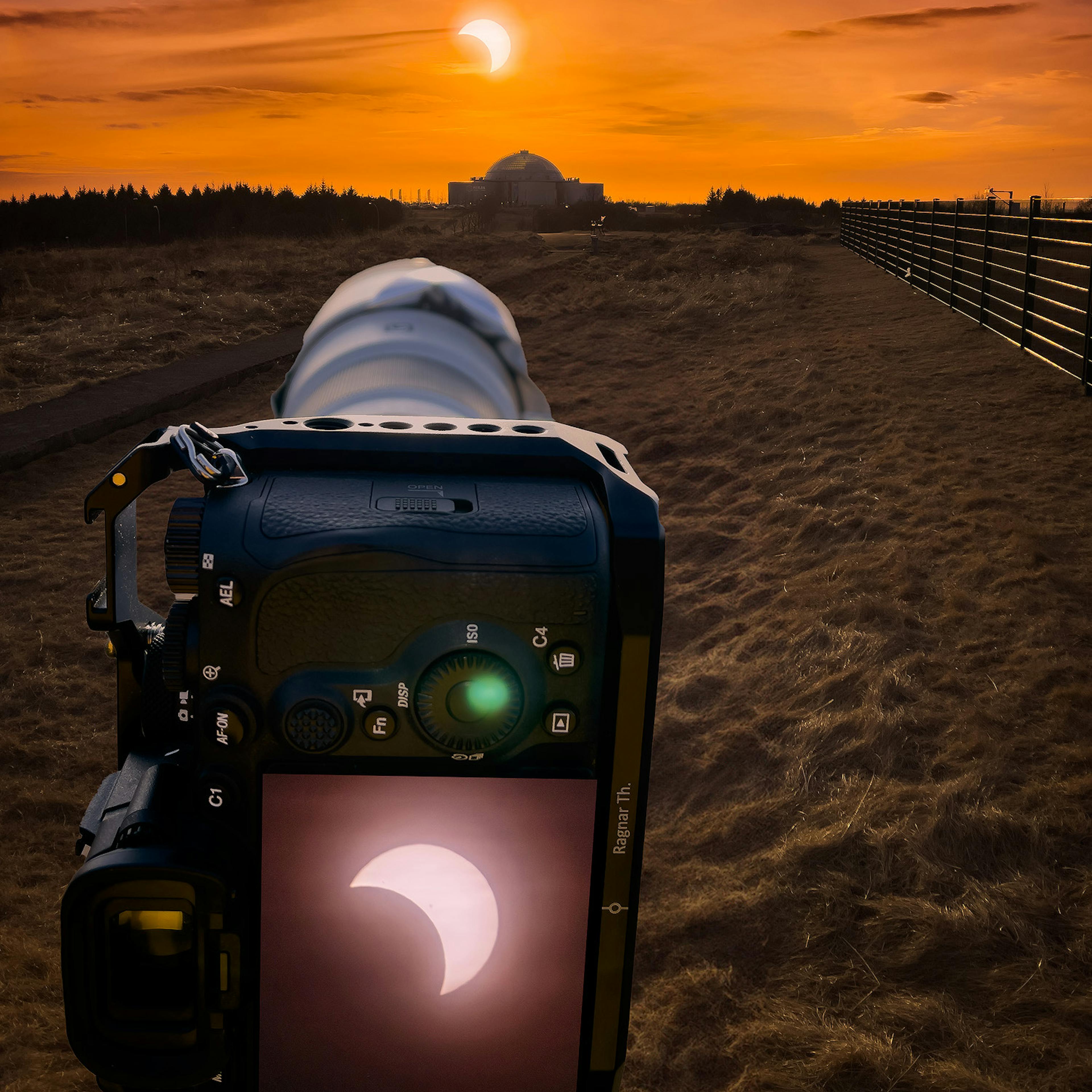 A camera taking a photo of the solar eclipse