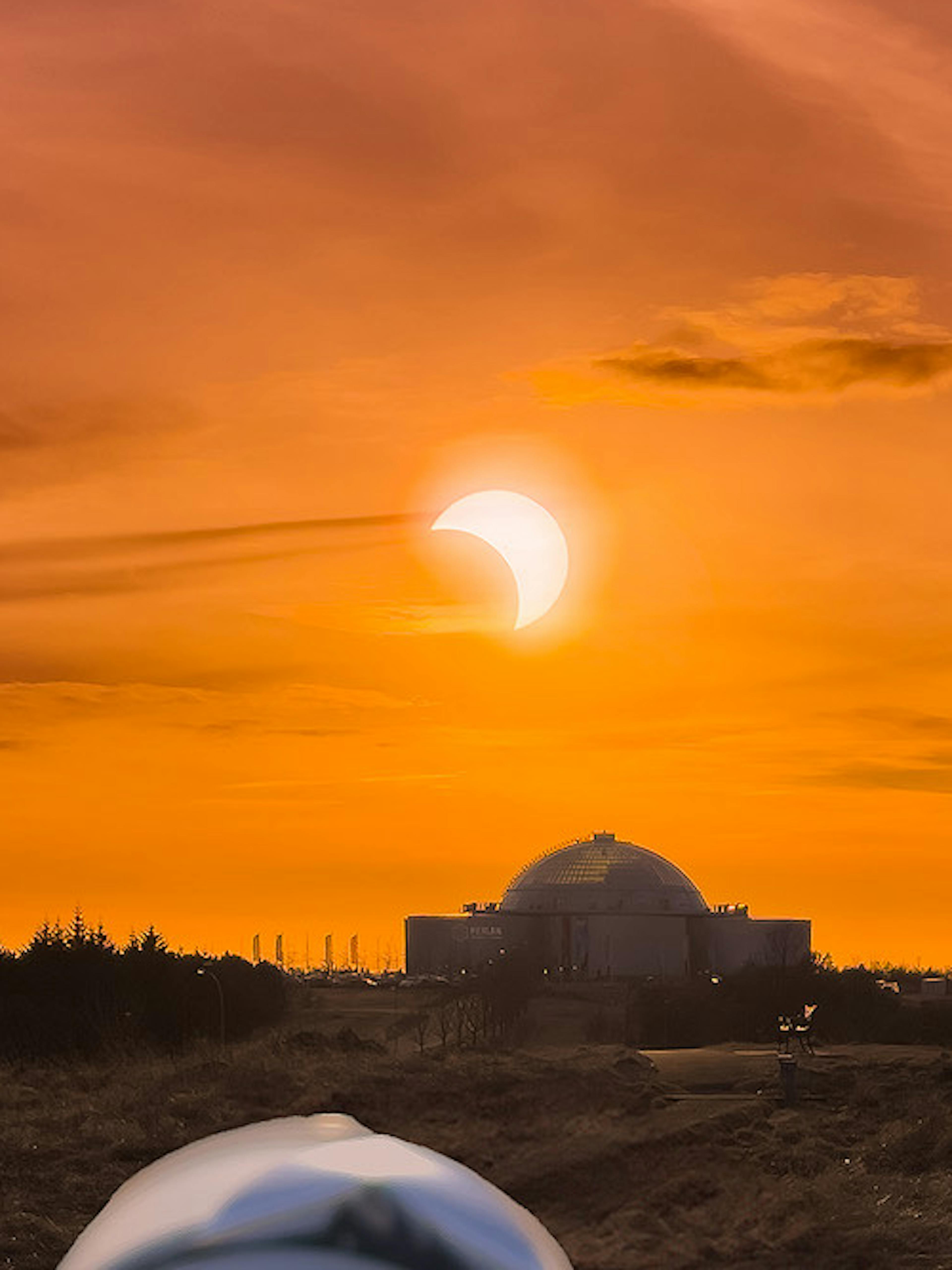 A camera taking a photo of the solar eclipse