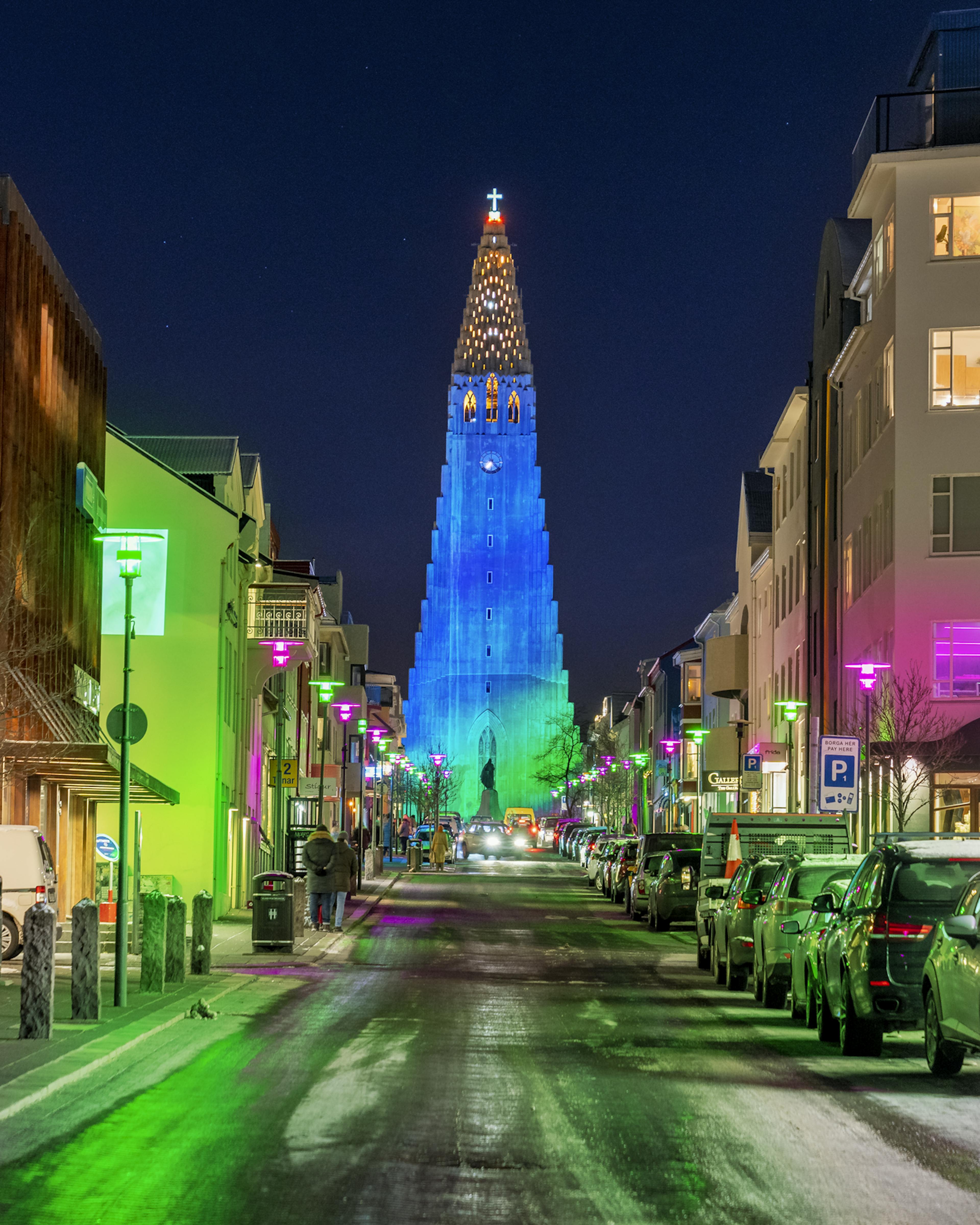 hallgrimskirkja church in reykjavik lit up by neon lights in the night