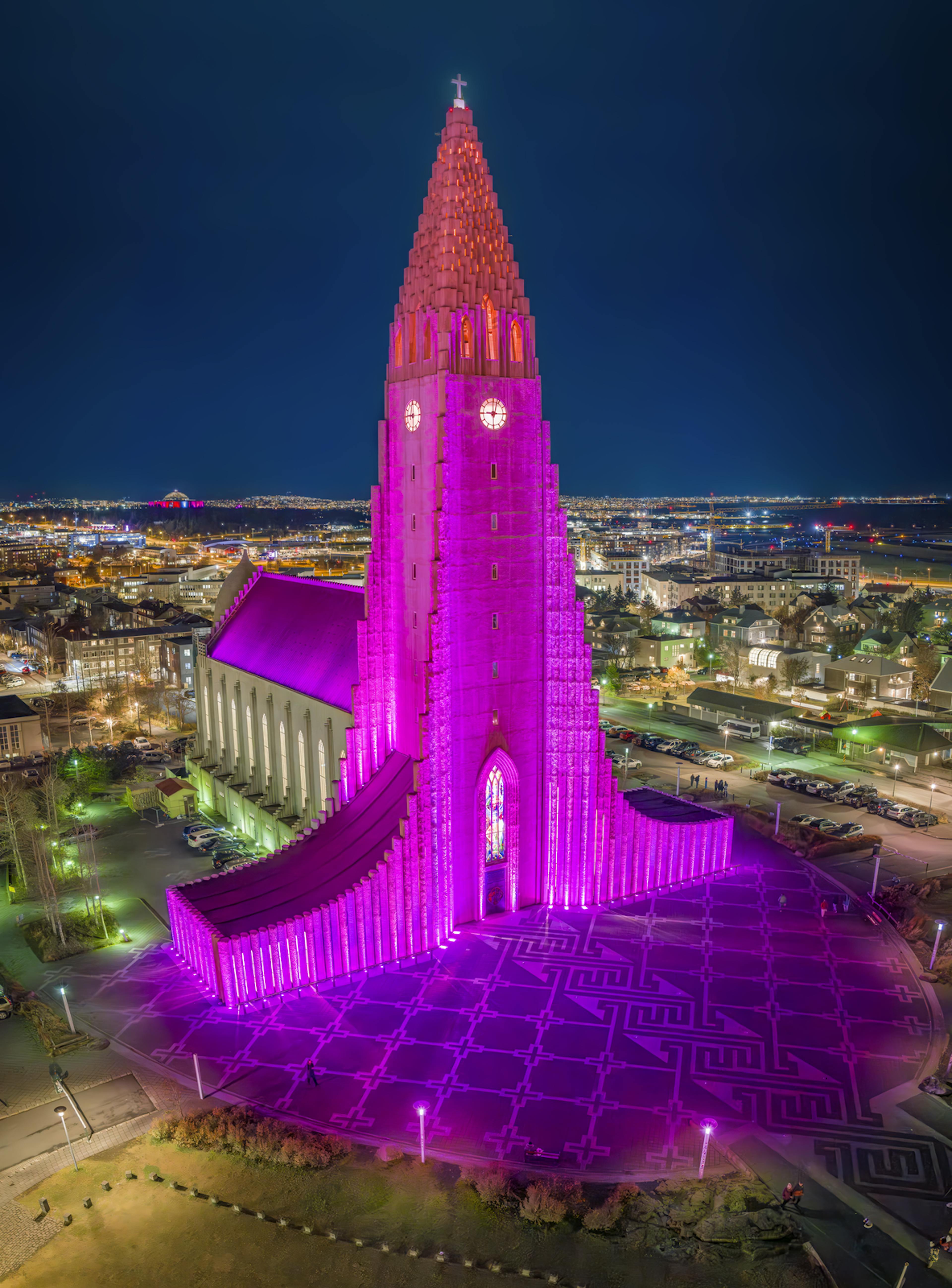 reykjavik church hallgrimskirkja lit up by pink neon lights