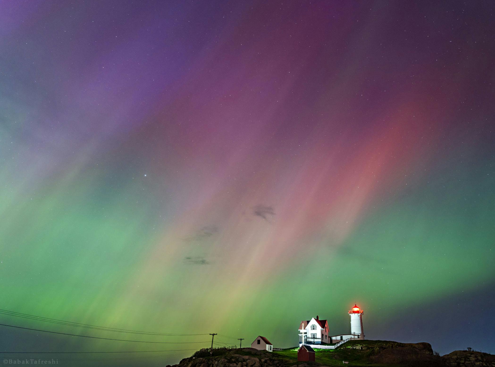 Red, green and purple northern lights in Reykjavik in January at Grotta Lighthouse