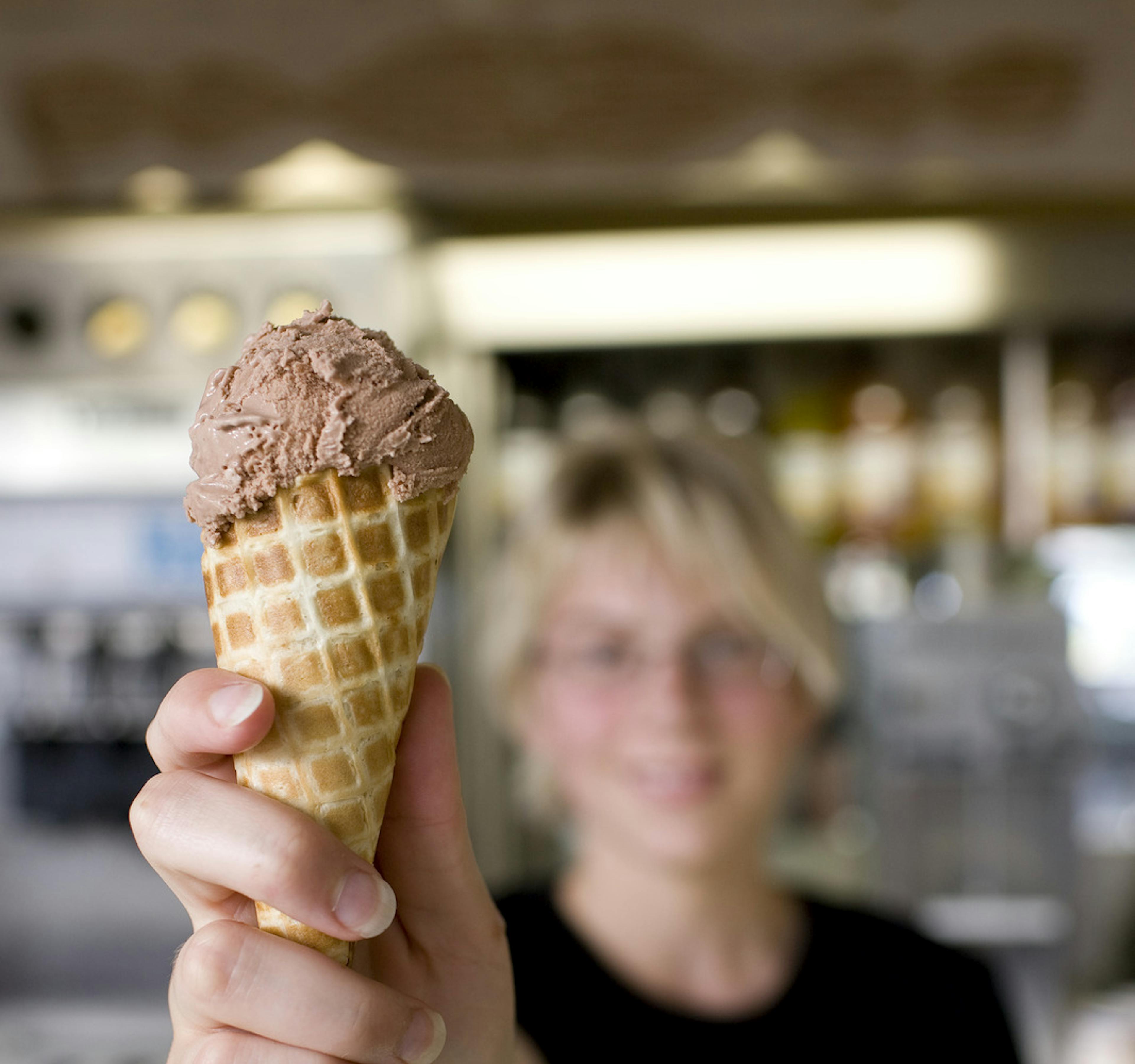 Woman handing over chocolate icecream