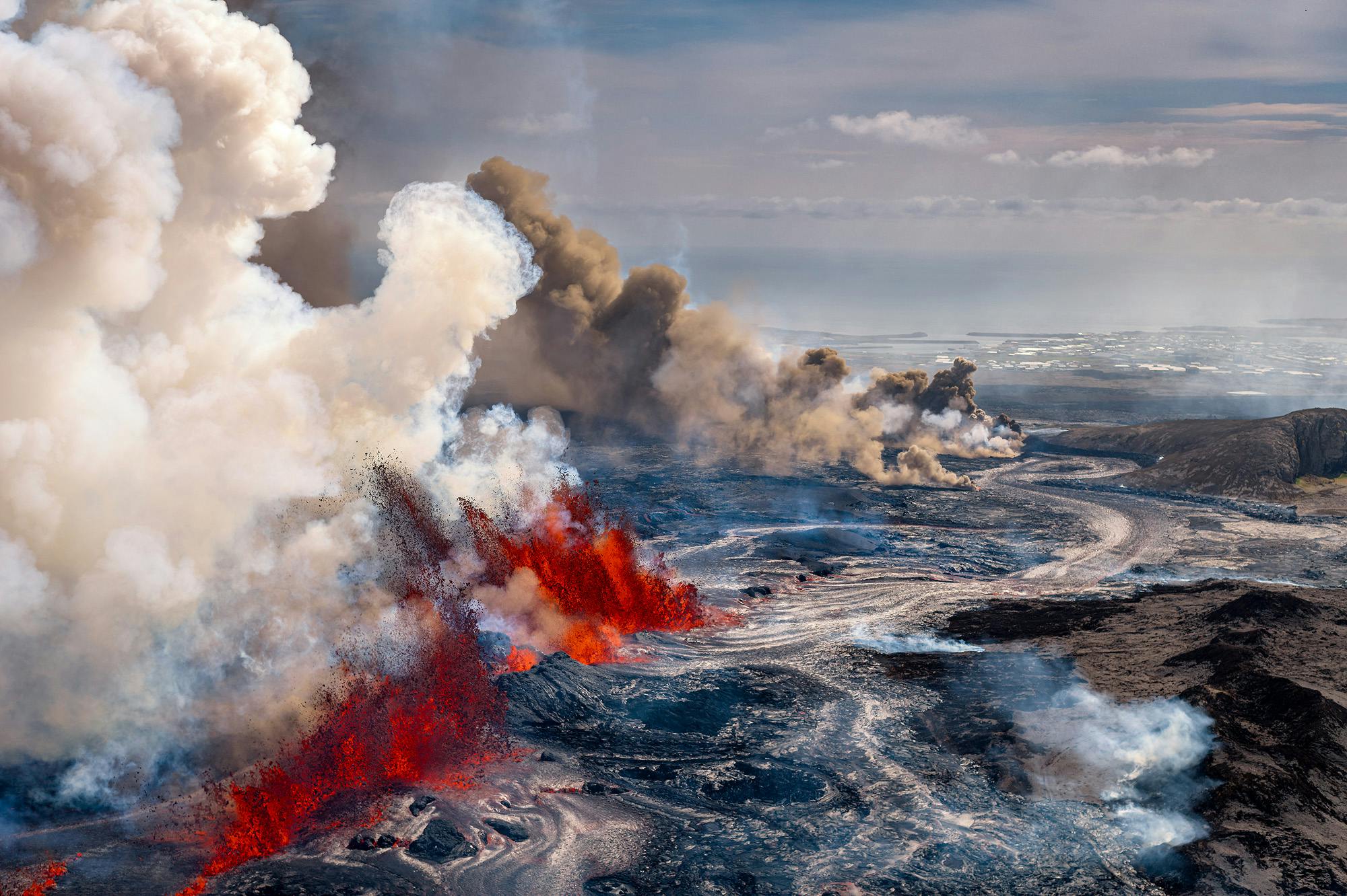 Arial shot of lava spewing out of sunhnúksgígar crater row eruption