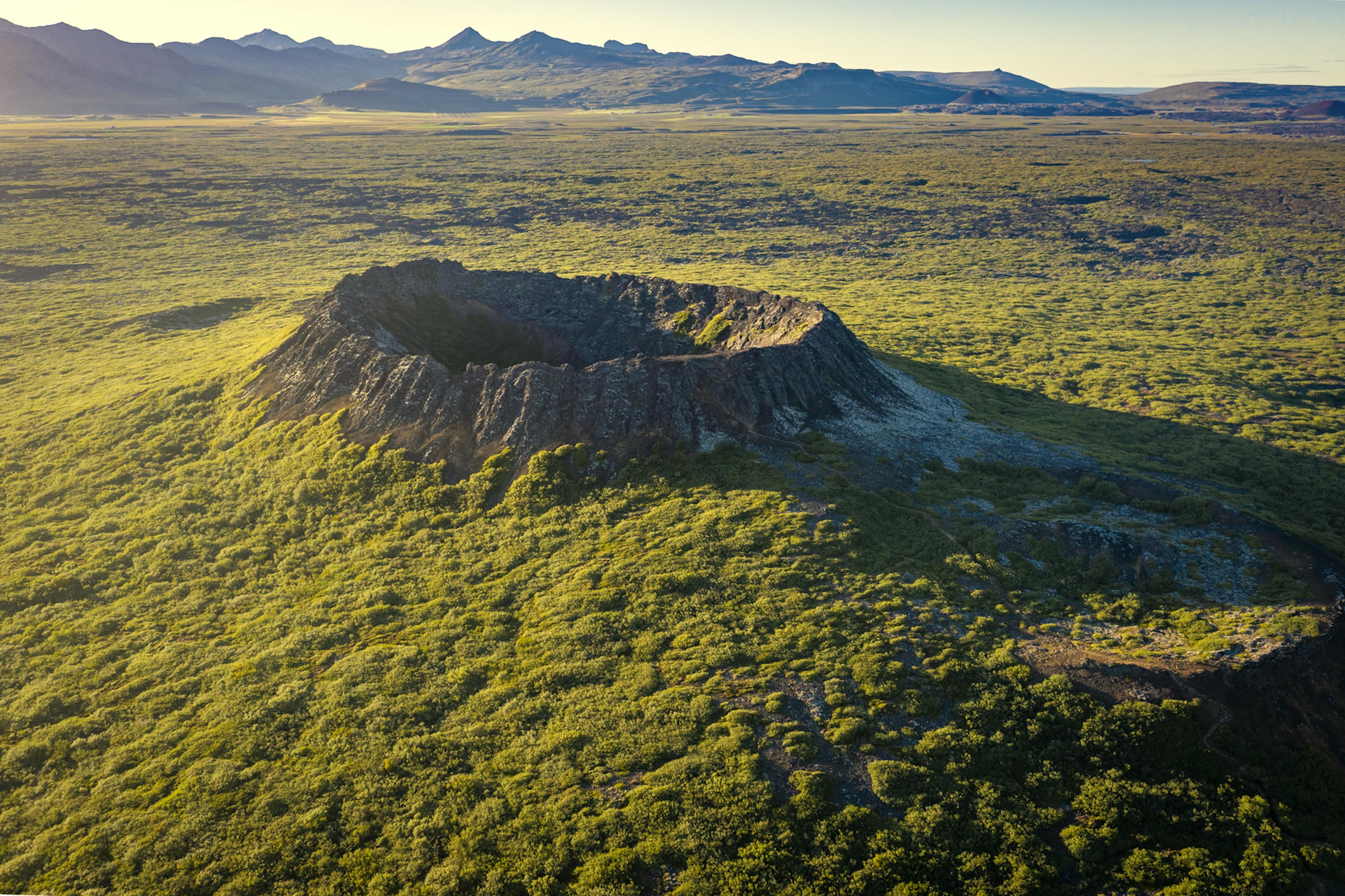 cinder cone volcano with lush greenery around