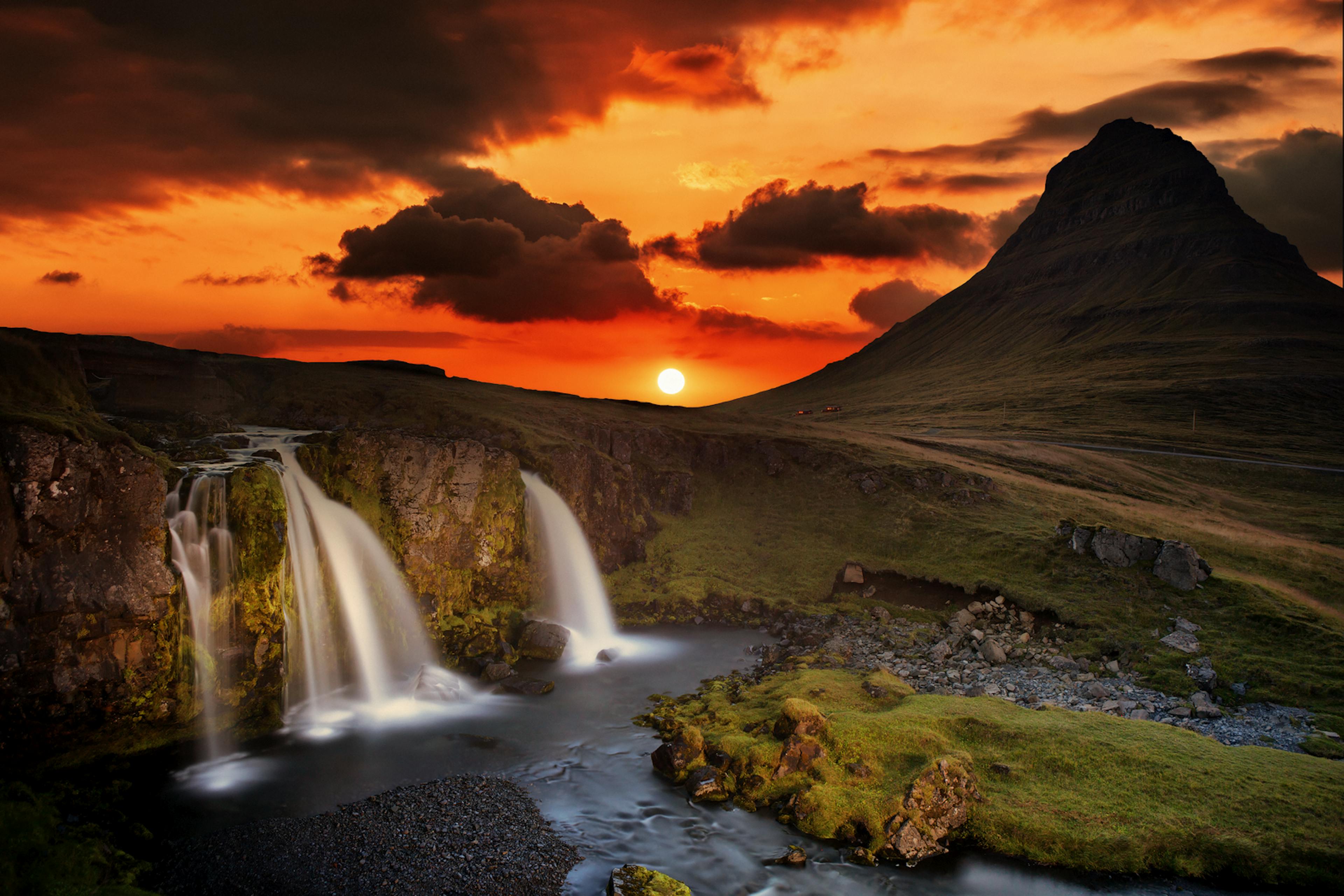 Kirkjufellsfoss Waterfall during sunset with Mt. Kirkjufell in background