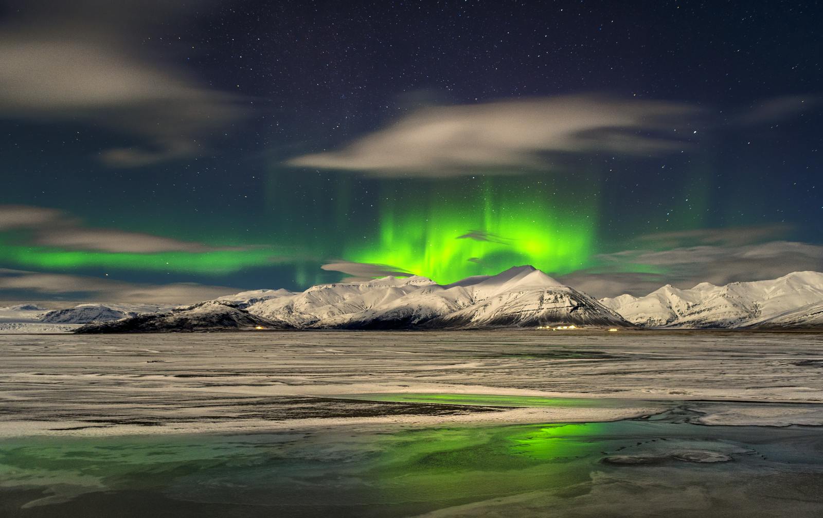 Hoffellsjökull Glacier during winter with green northern lights in the sky