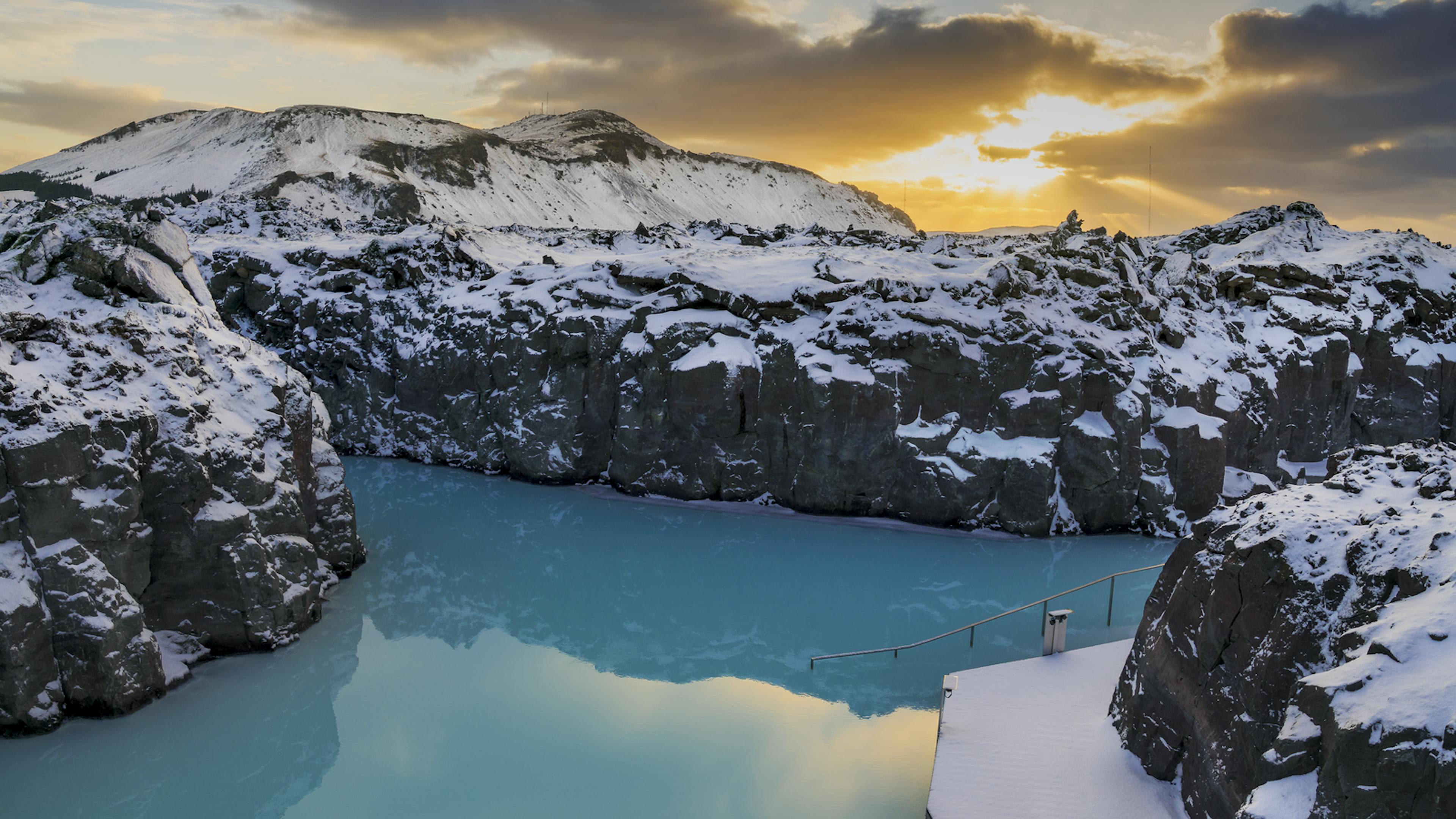 blue lagoon over winter with snow on lava rocks