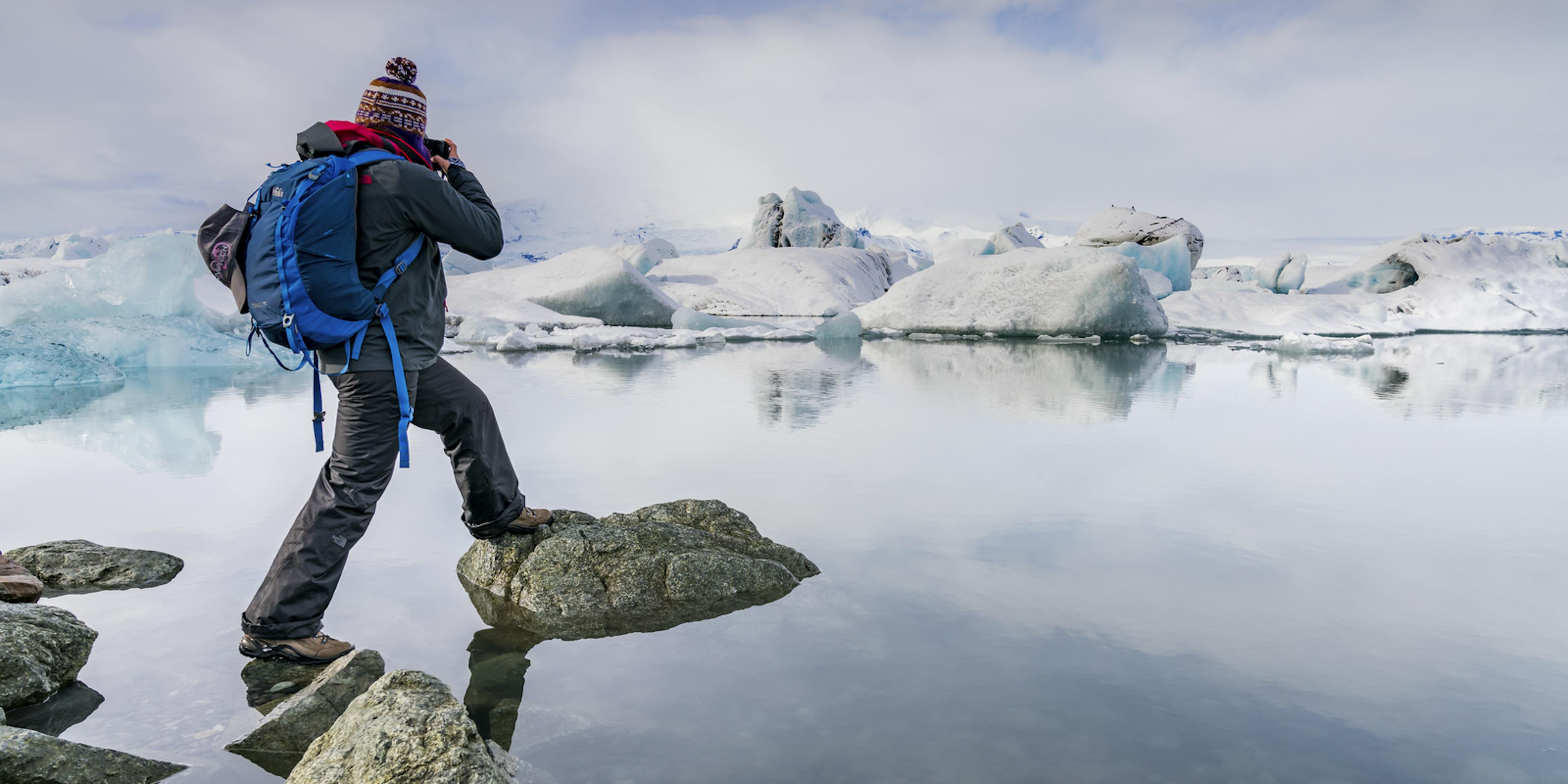 Tourist taking picture at jokulsarlon lagoon