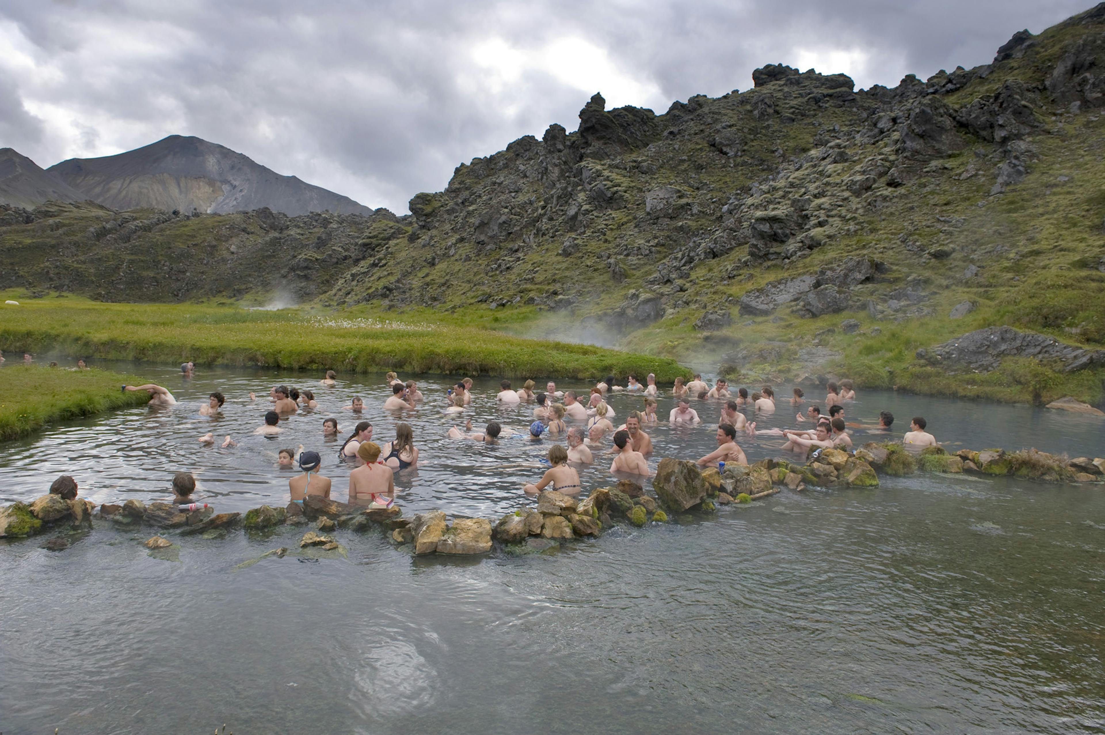 group of people bathing in hot sping in landmannalaugar
