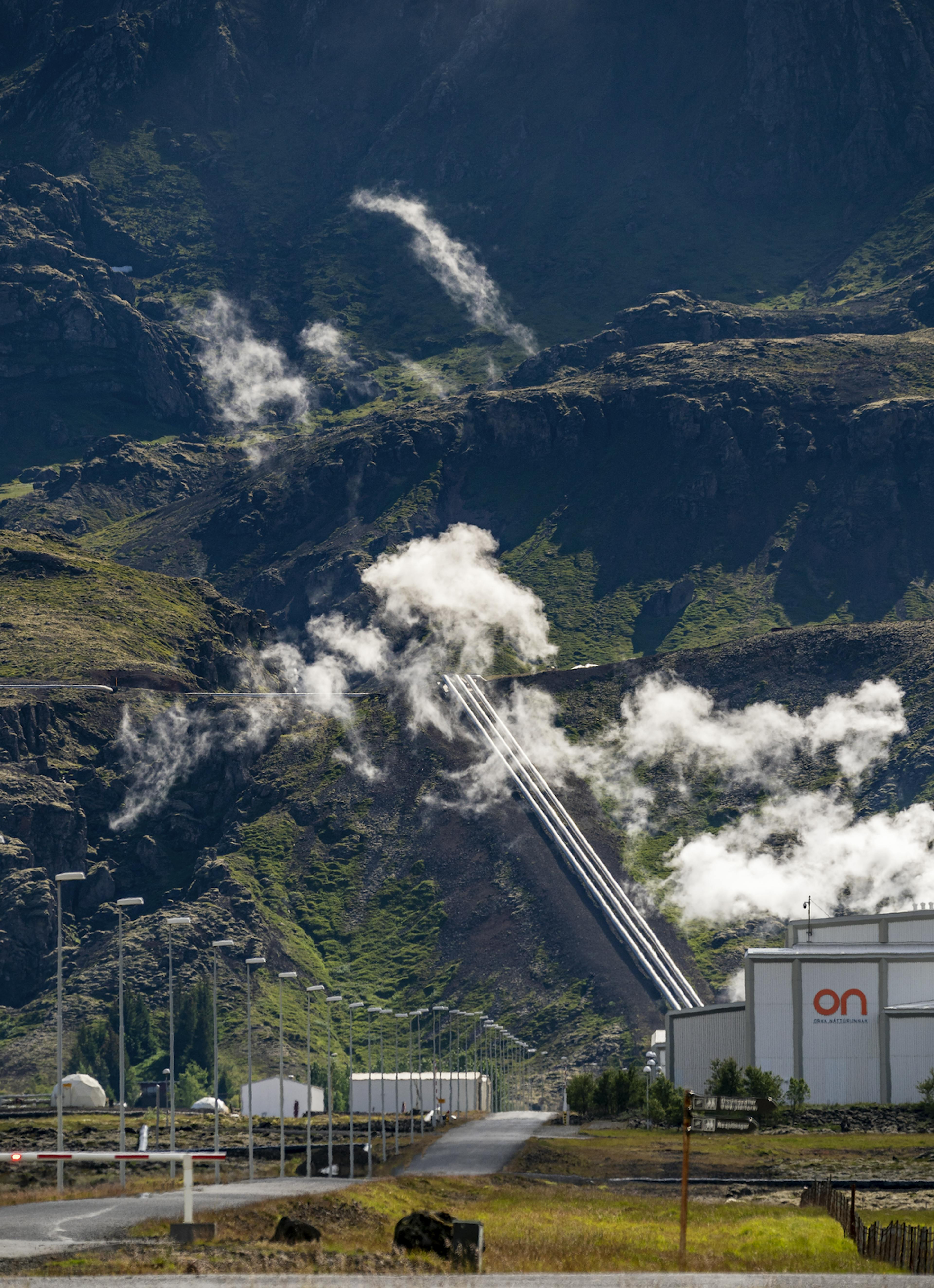 geothermal plant in iceland with mountain background