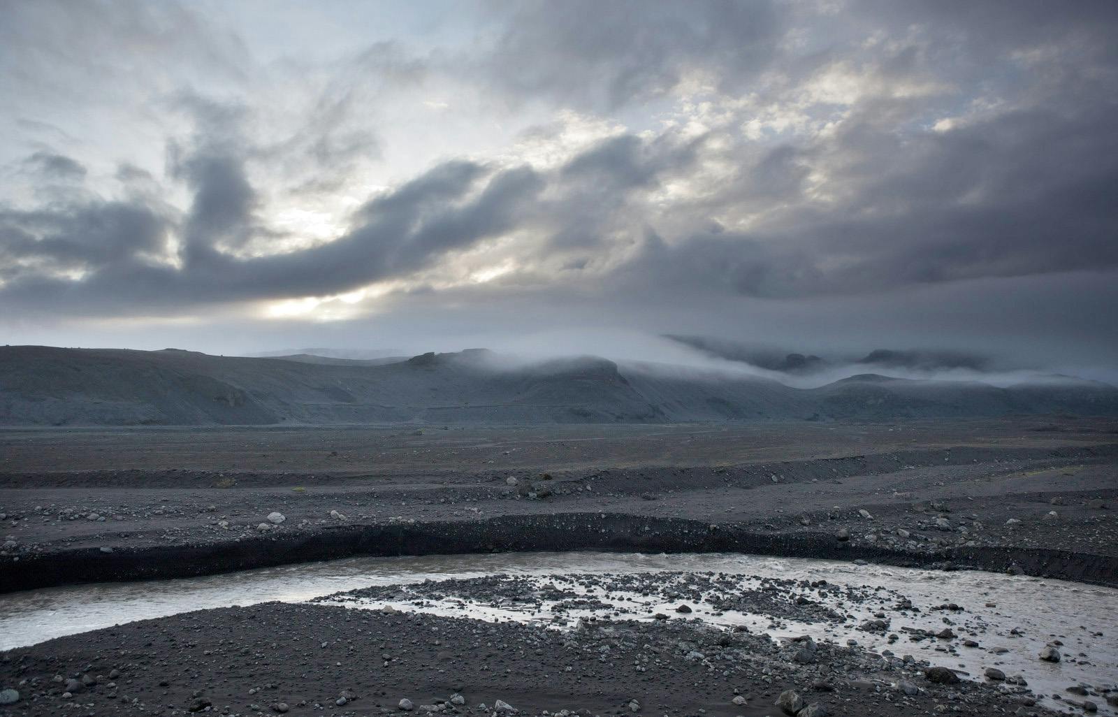 black sand with a river in sólheimasandur