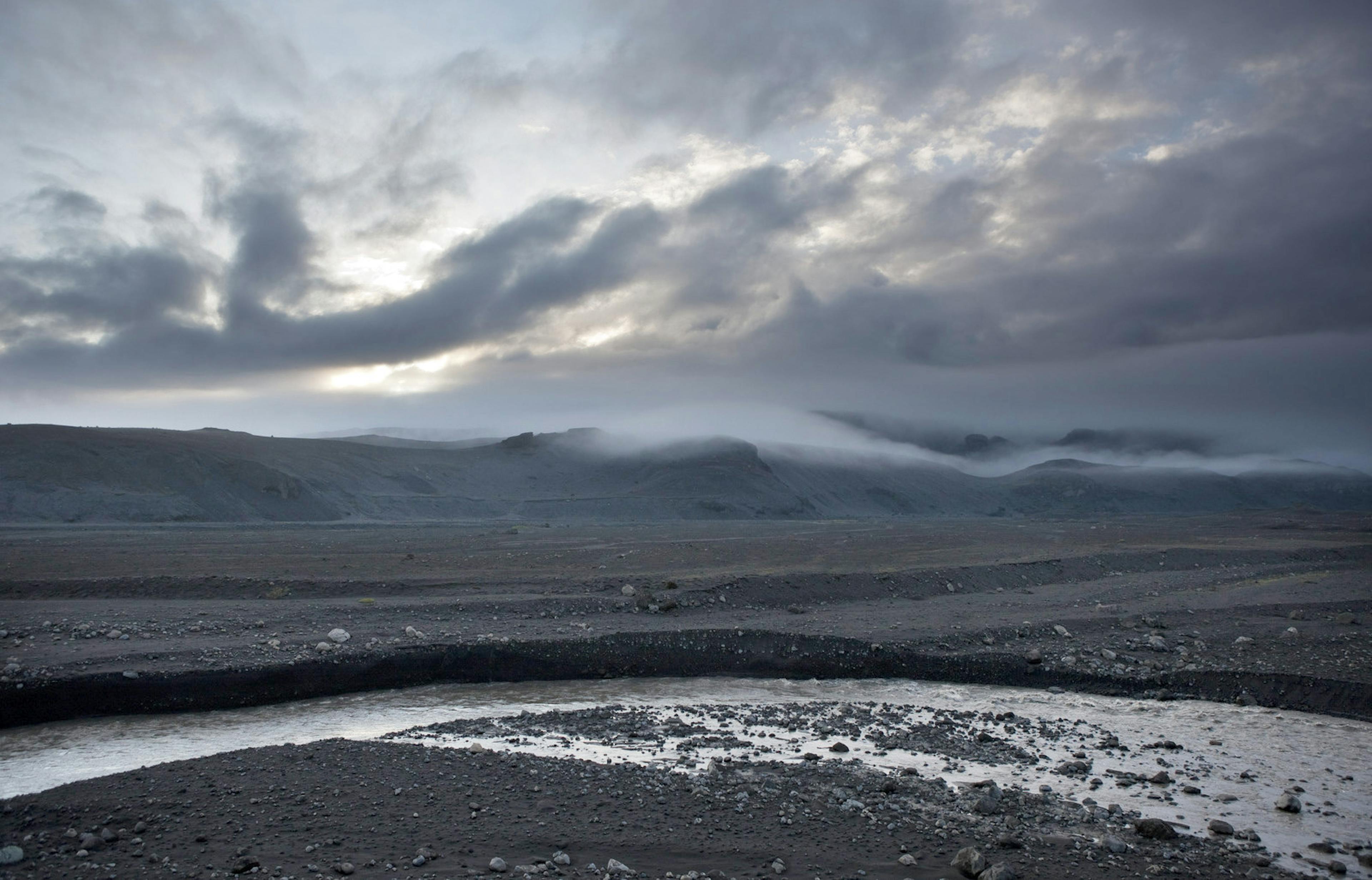 black sand with a river in sólheimasandur