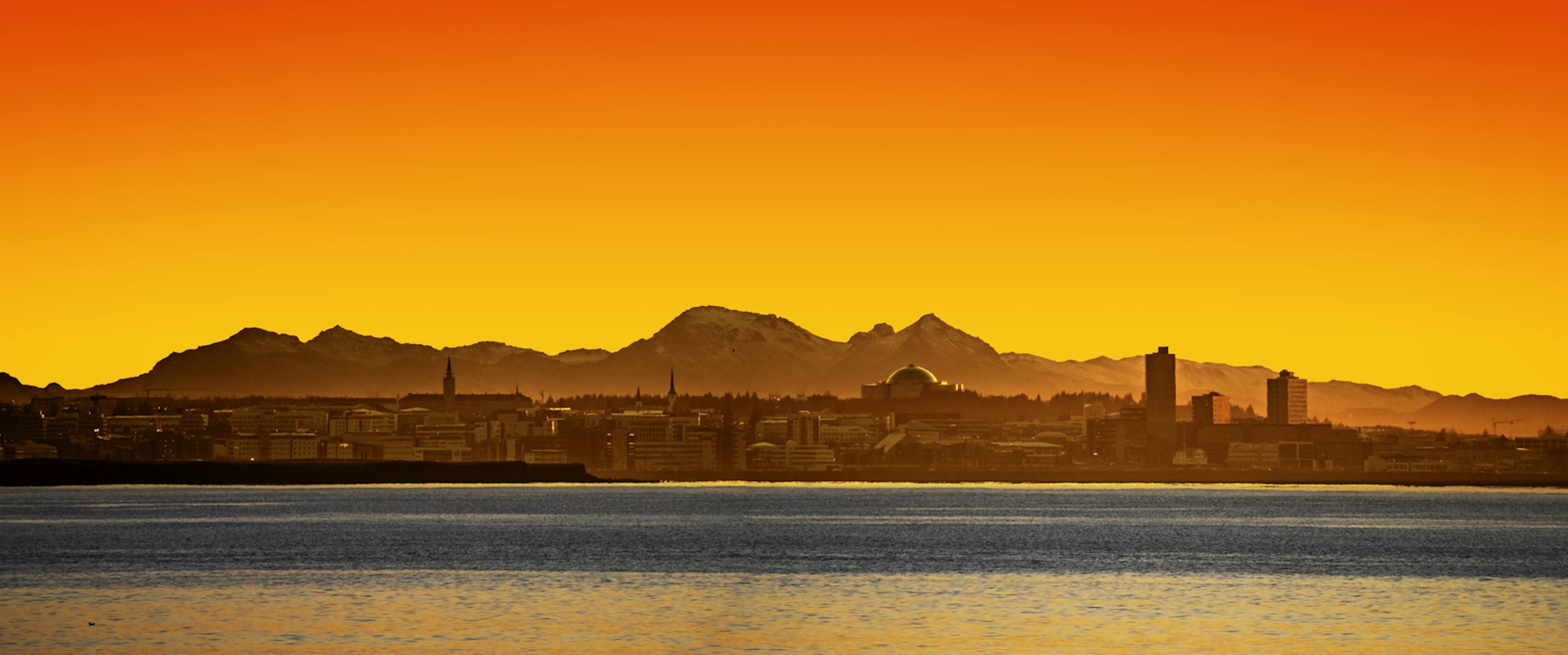 Reykjavík with Bláfjöll mountains in the background during sunset