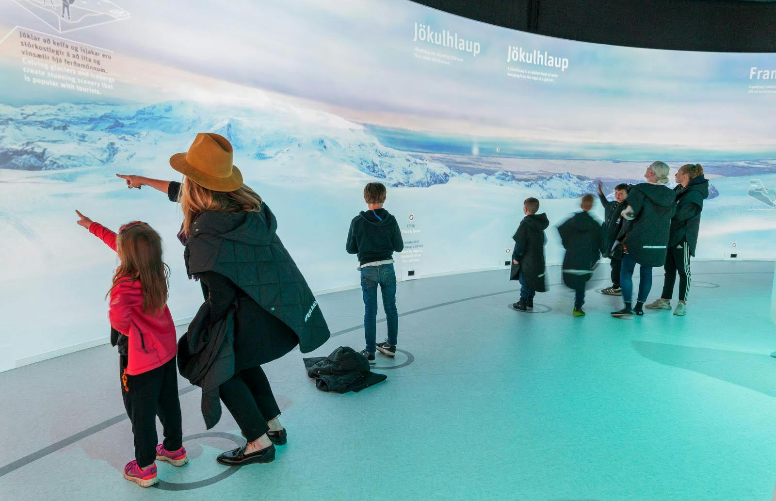 Tourists interacting with glacier exhibit in Reykjavík