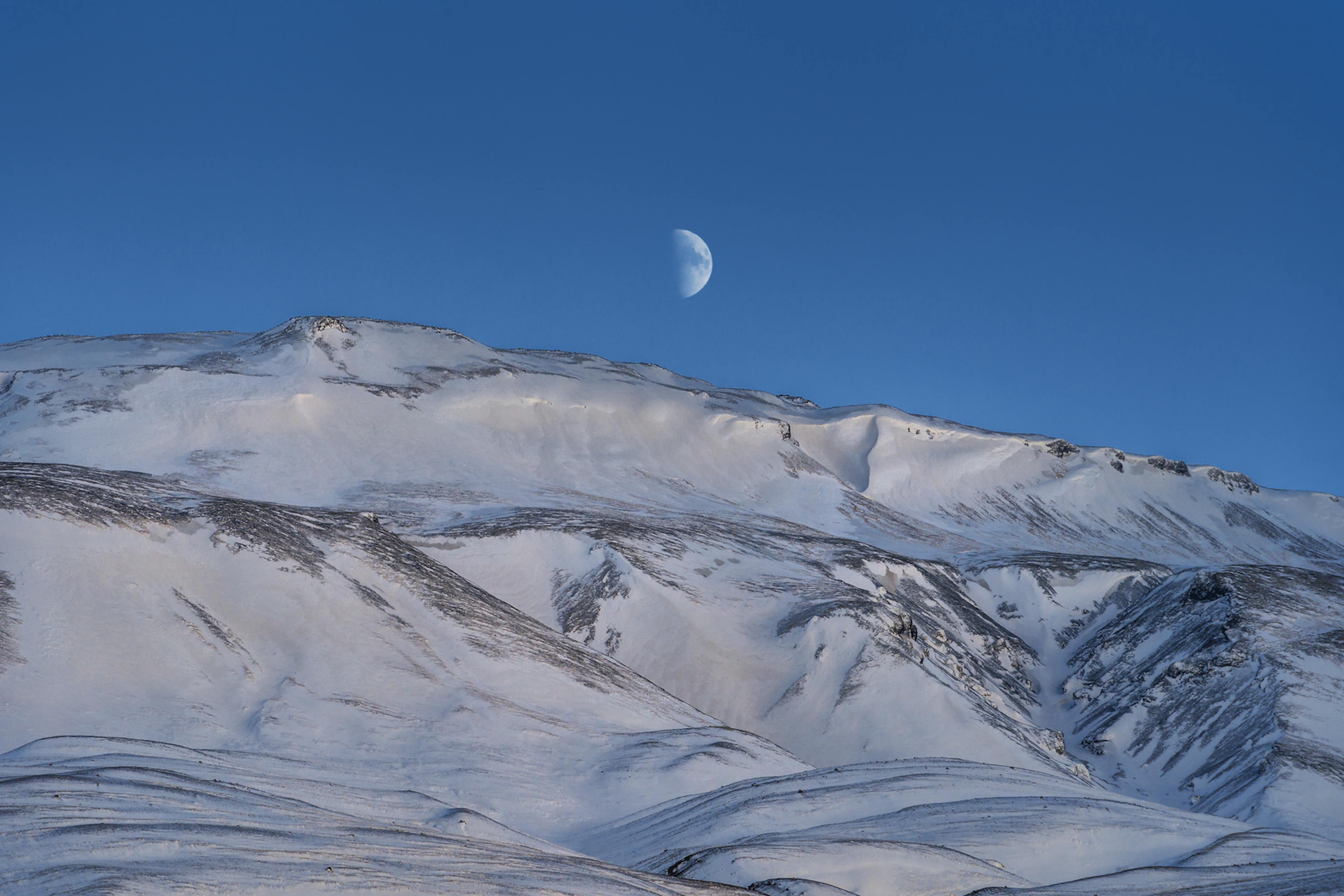 þórólfsfell covered in snow with the moon in the background