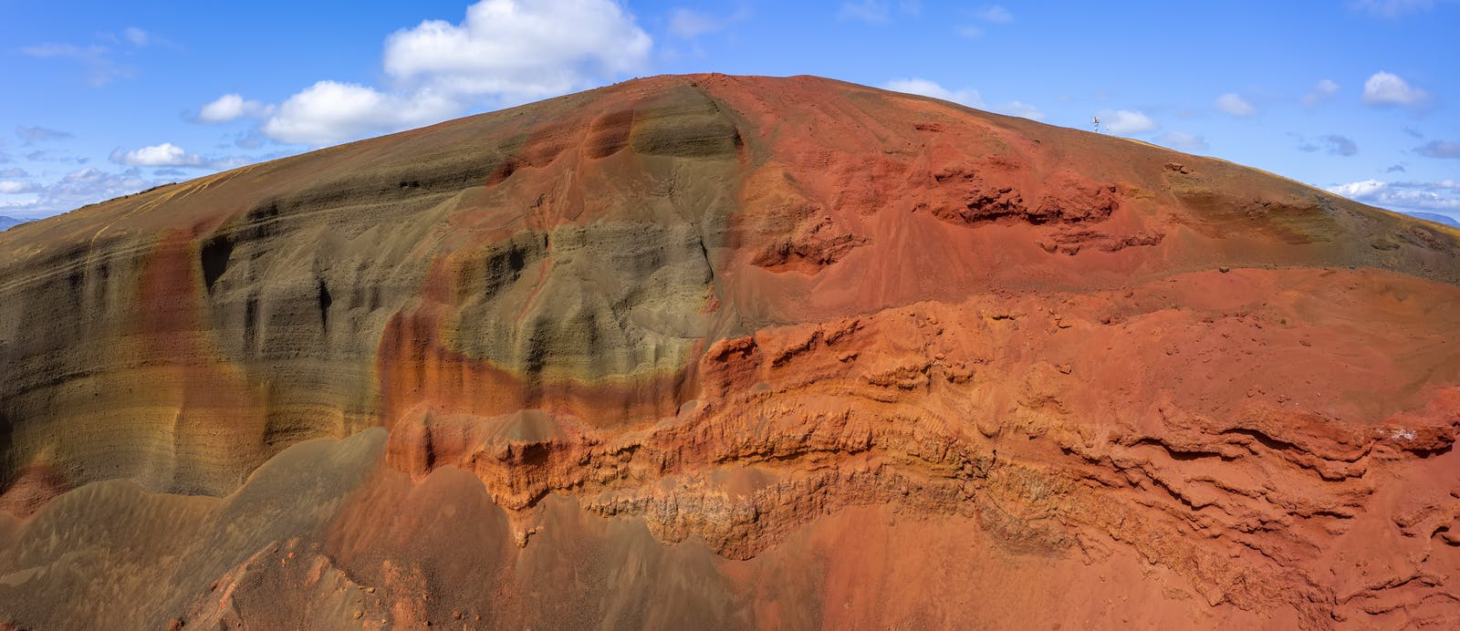 Búrfell mountain in the summer with red and green tint