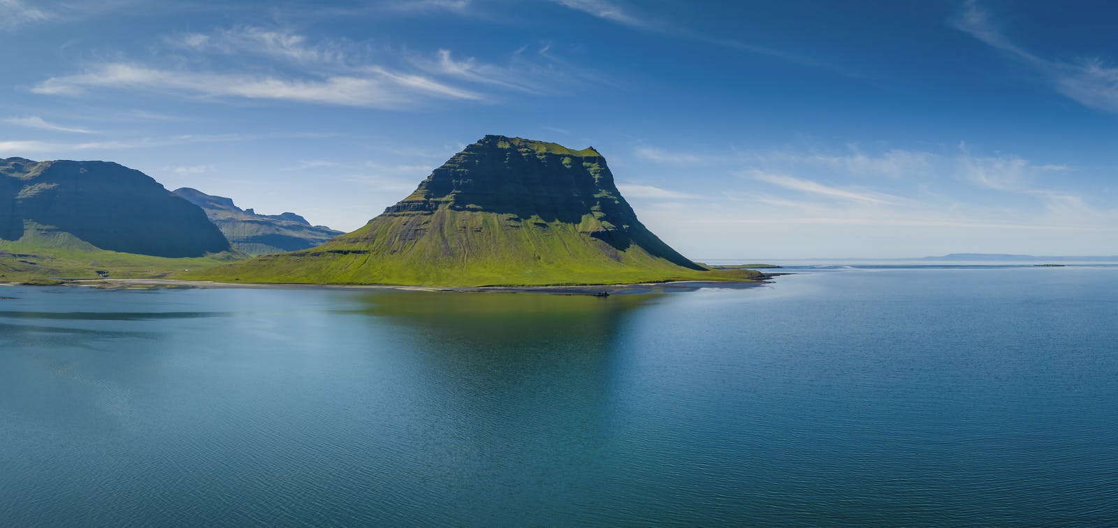 Kirkjufell in the summer surrounded by the ocean