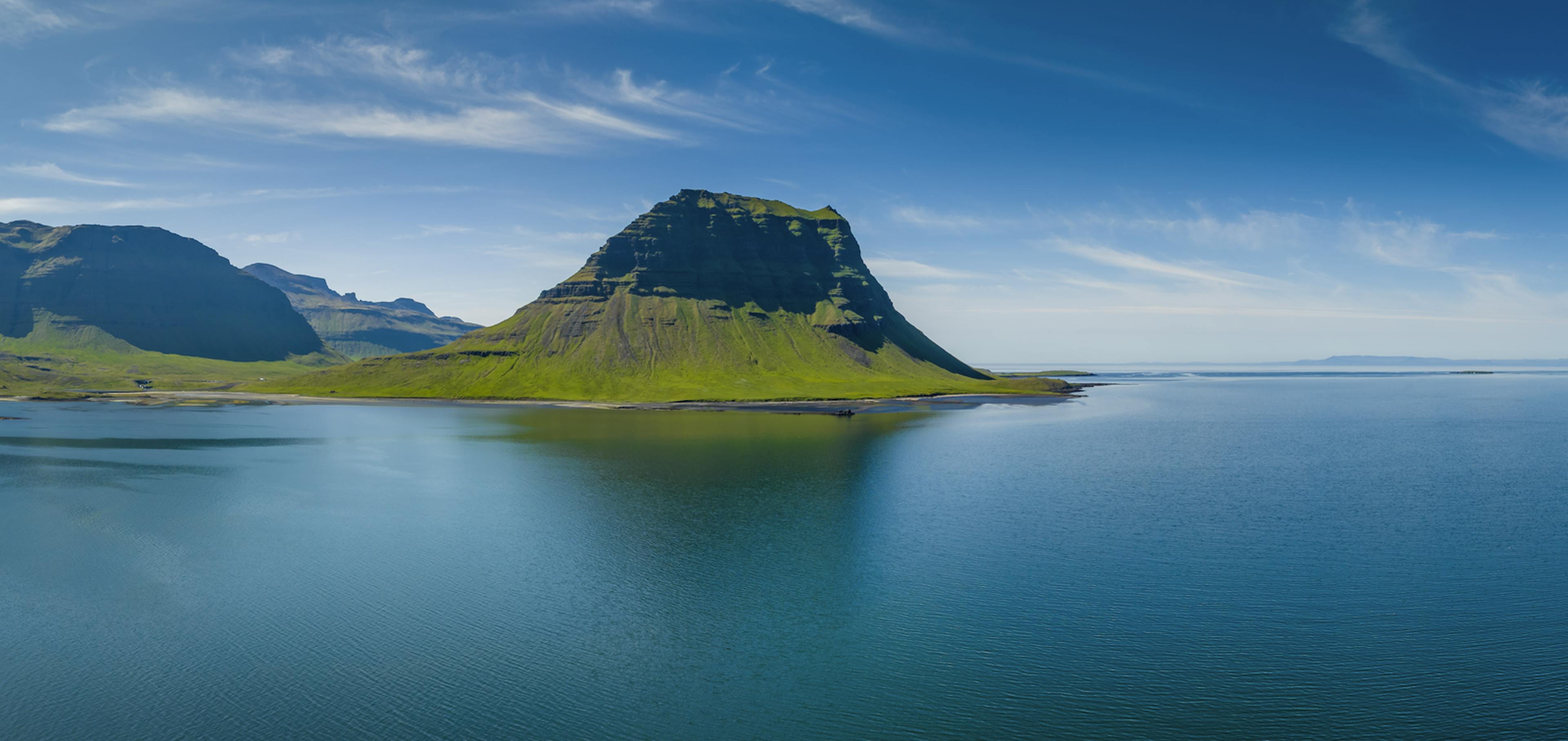 Kirkjufell in the summer surrounded by the ocean
