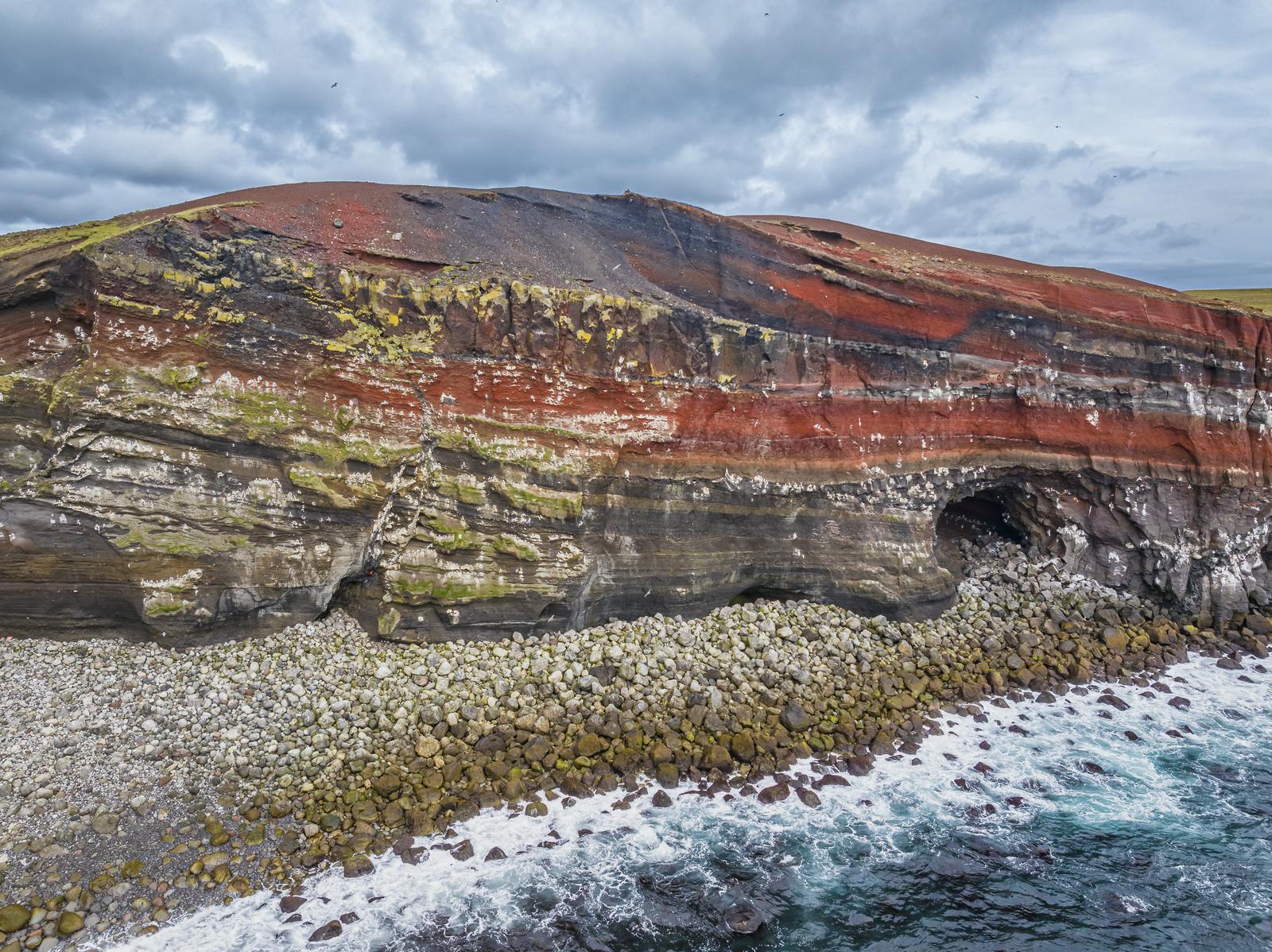 A red cliff and cave in Krýsuvík