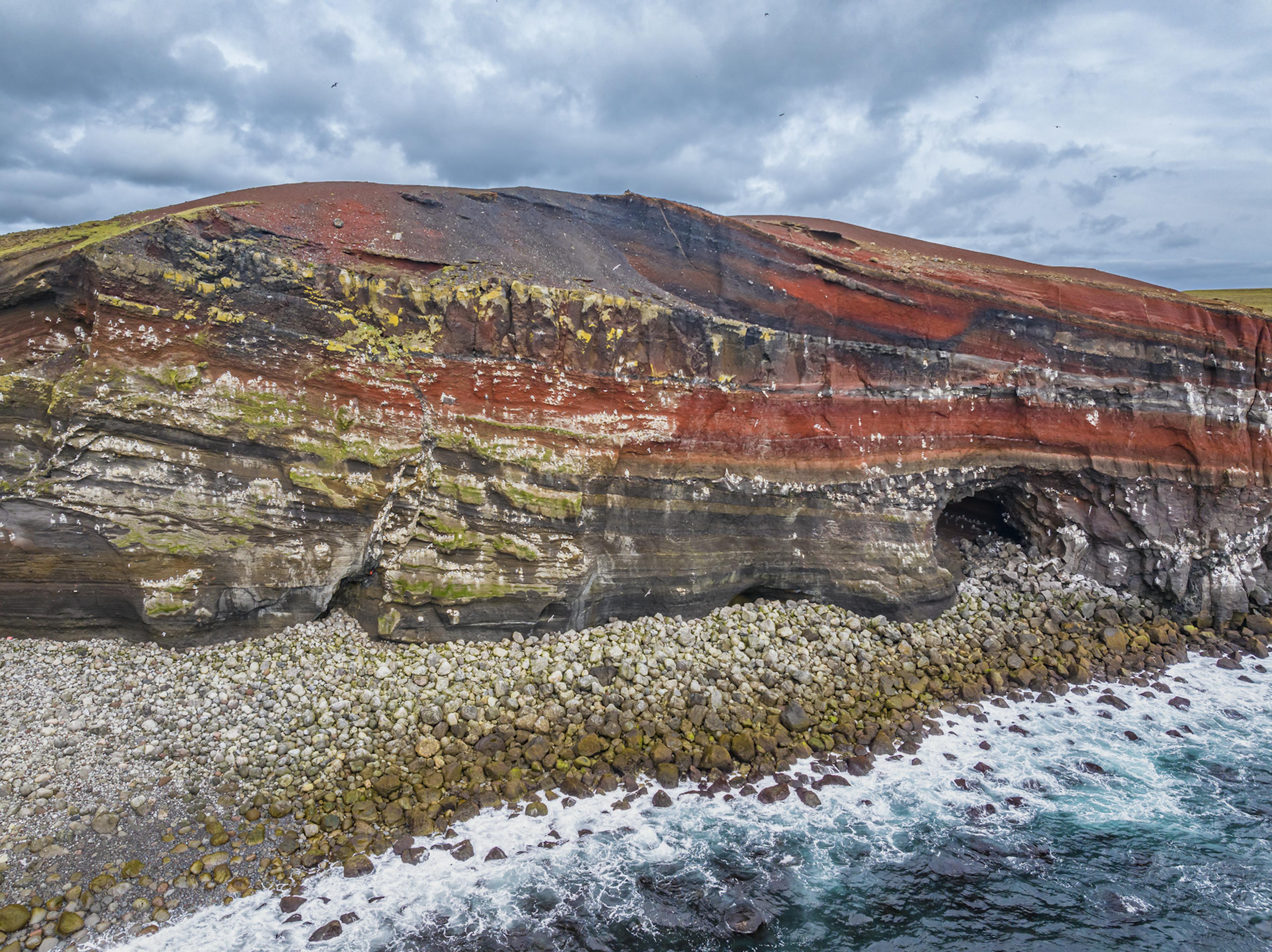 A red cliff and cave in Krýsuvík