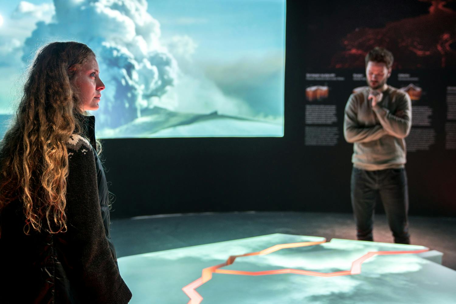 tourists watching the volcanic exhibit