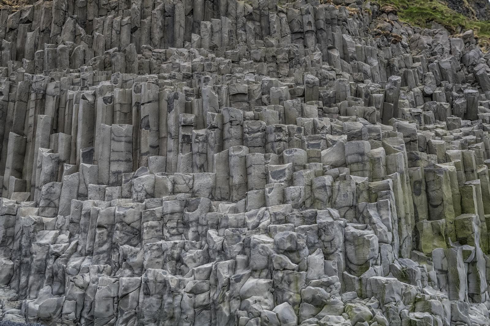 Gray basalt columns in iceland near the ocean