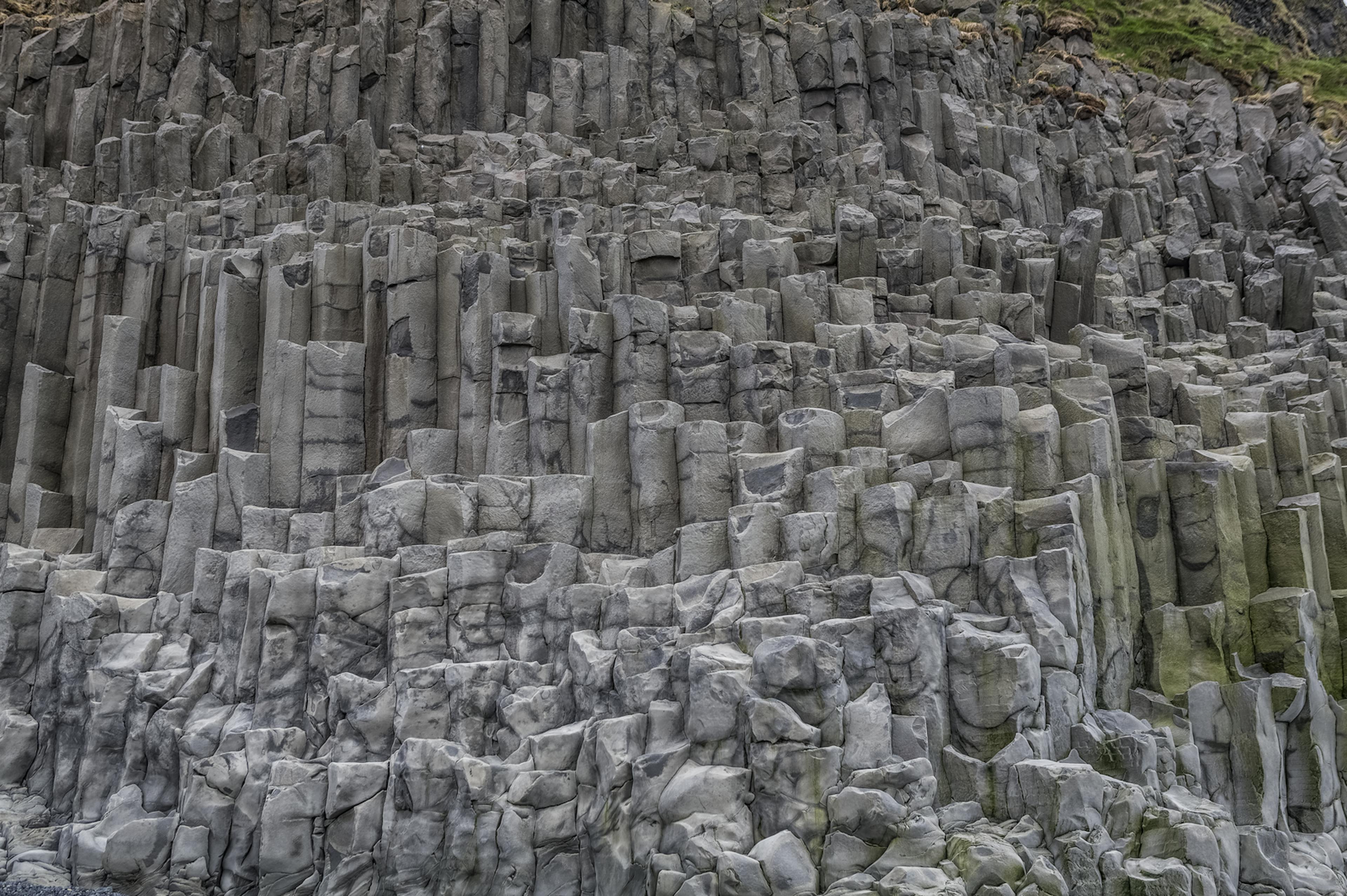 Gray basalt columns in iceland near the ocean