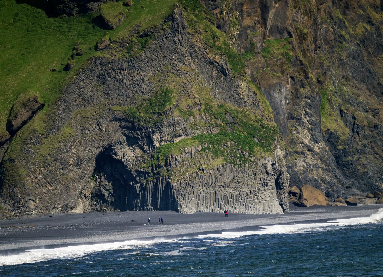 A wide view of the basalt columns on the black sand beach