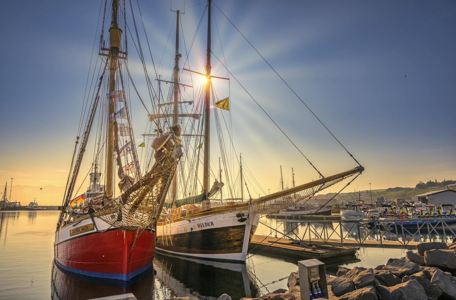 Whale watching ships in húsavík on a sunny day