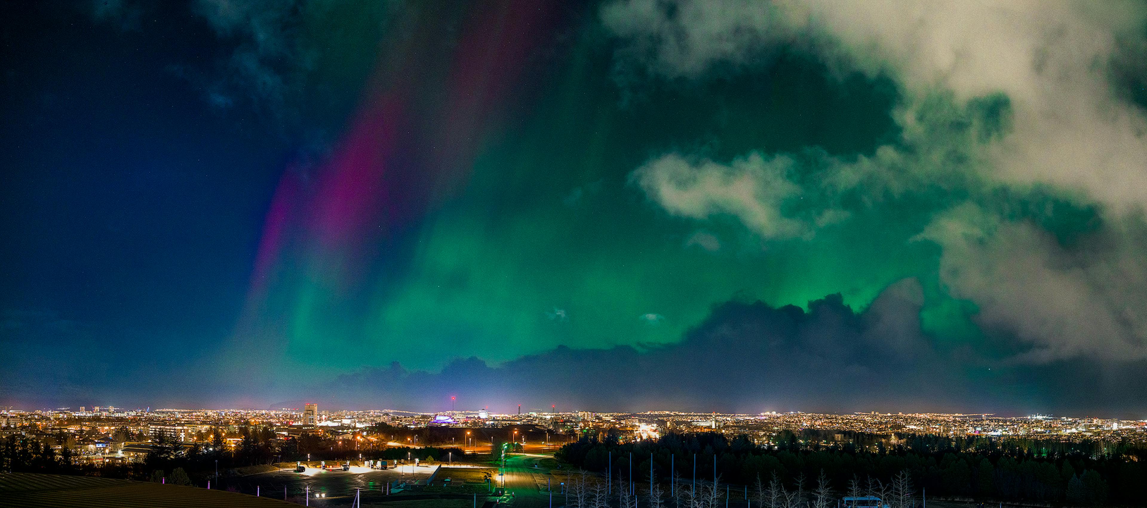 red and purple northern lights over reykajvik
