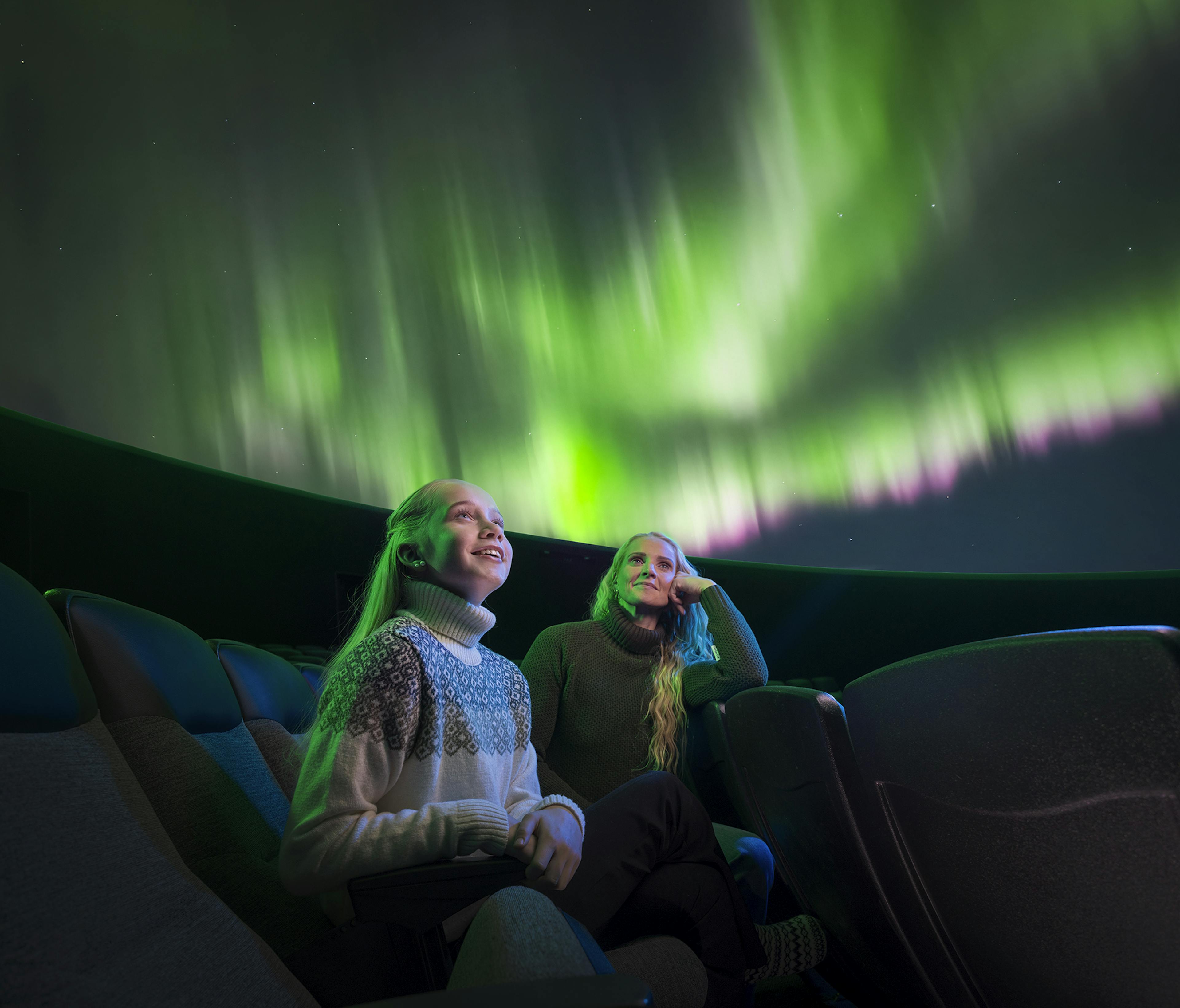 mother and daughter viewing the northern lights in reykjavik