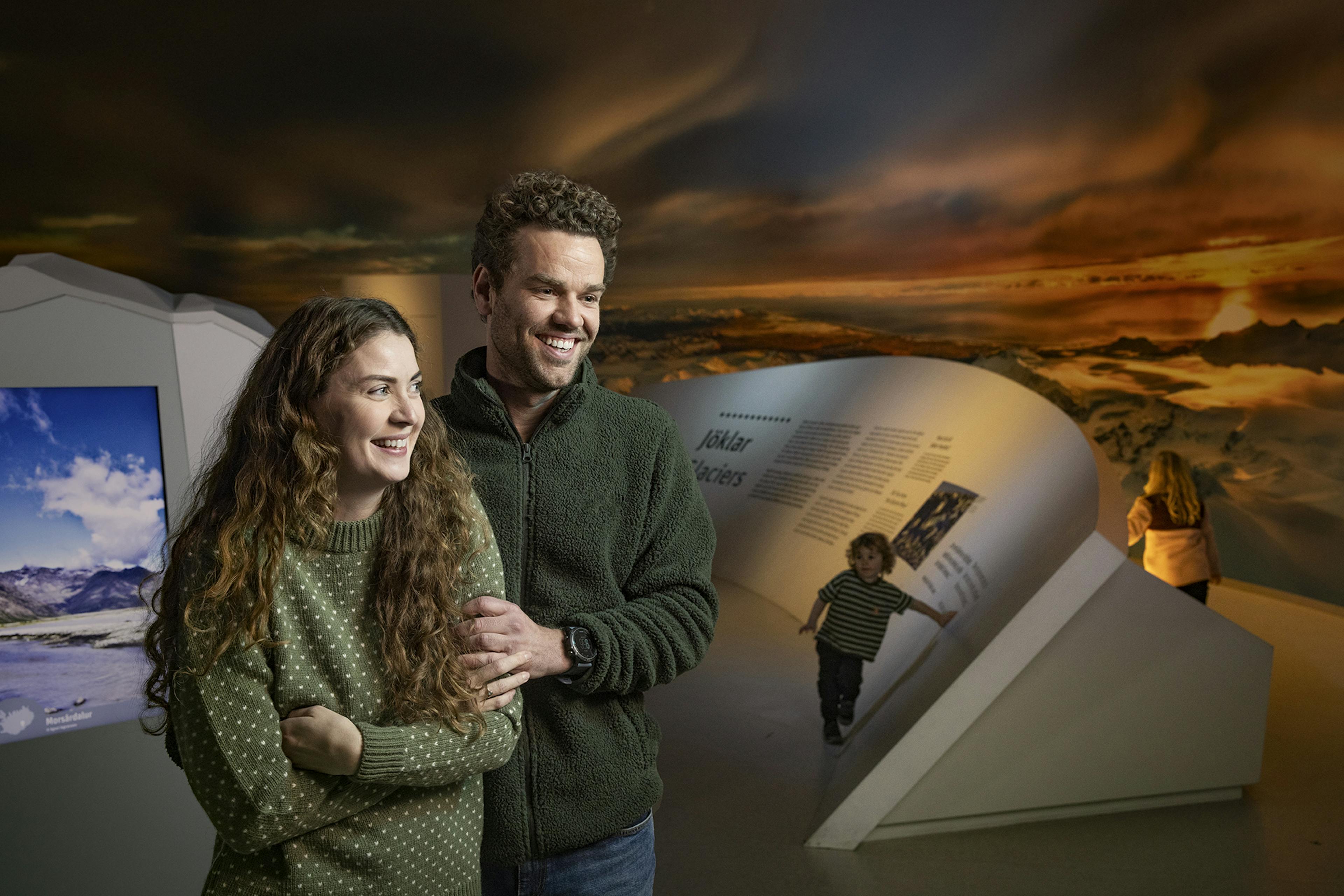 Family view the glacier exhibit in Reykjavik