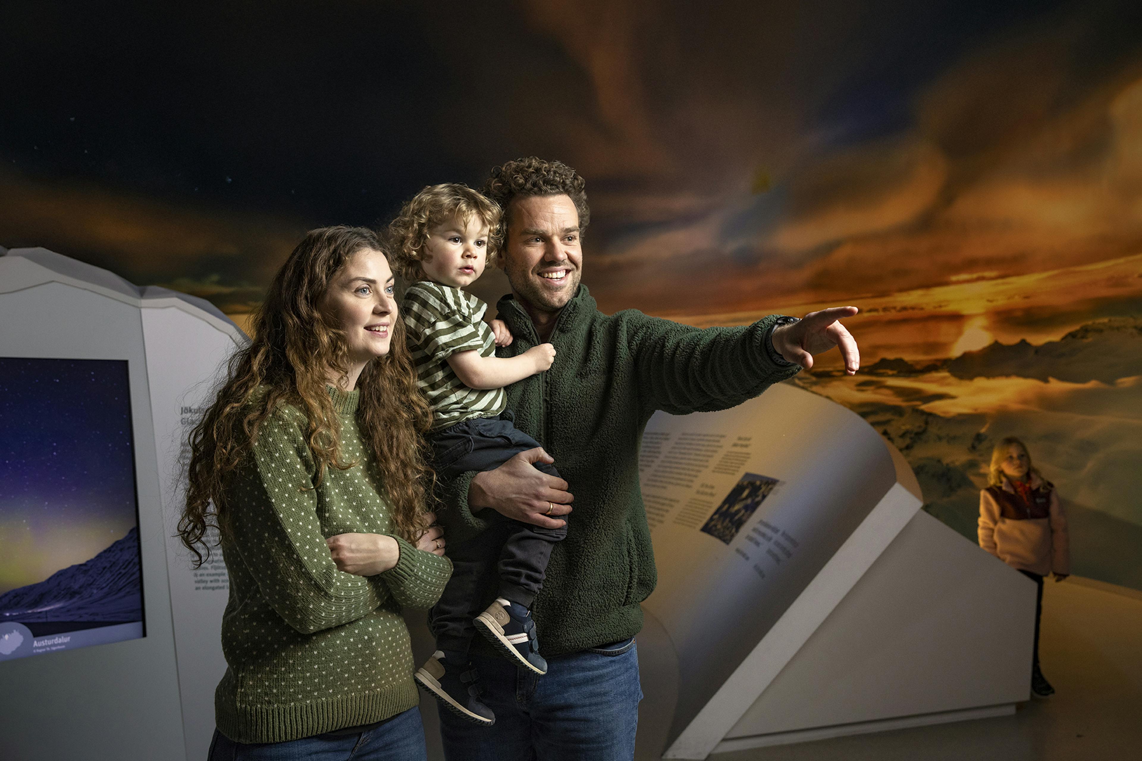 family with dad pointing in the glacier exhibit