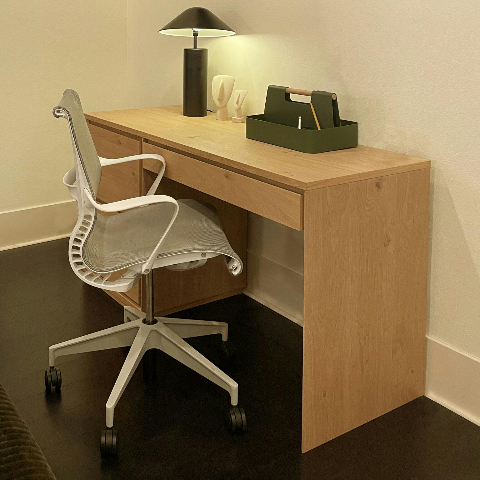 A compact desk and sleek ergonomic chair provide a calming spot to plan, journal or draw.