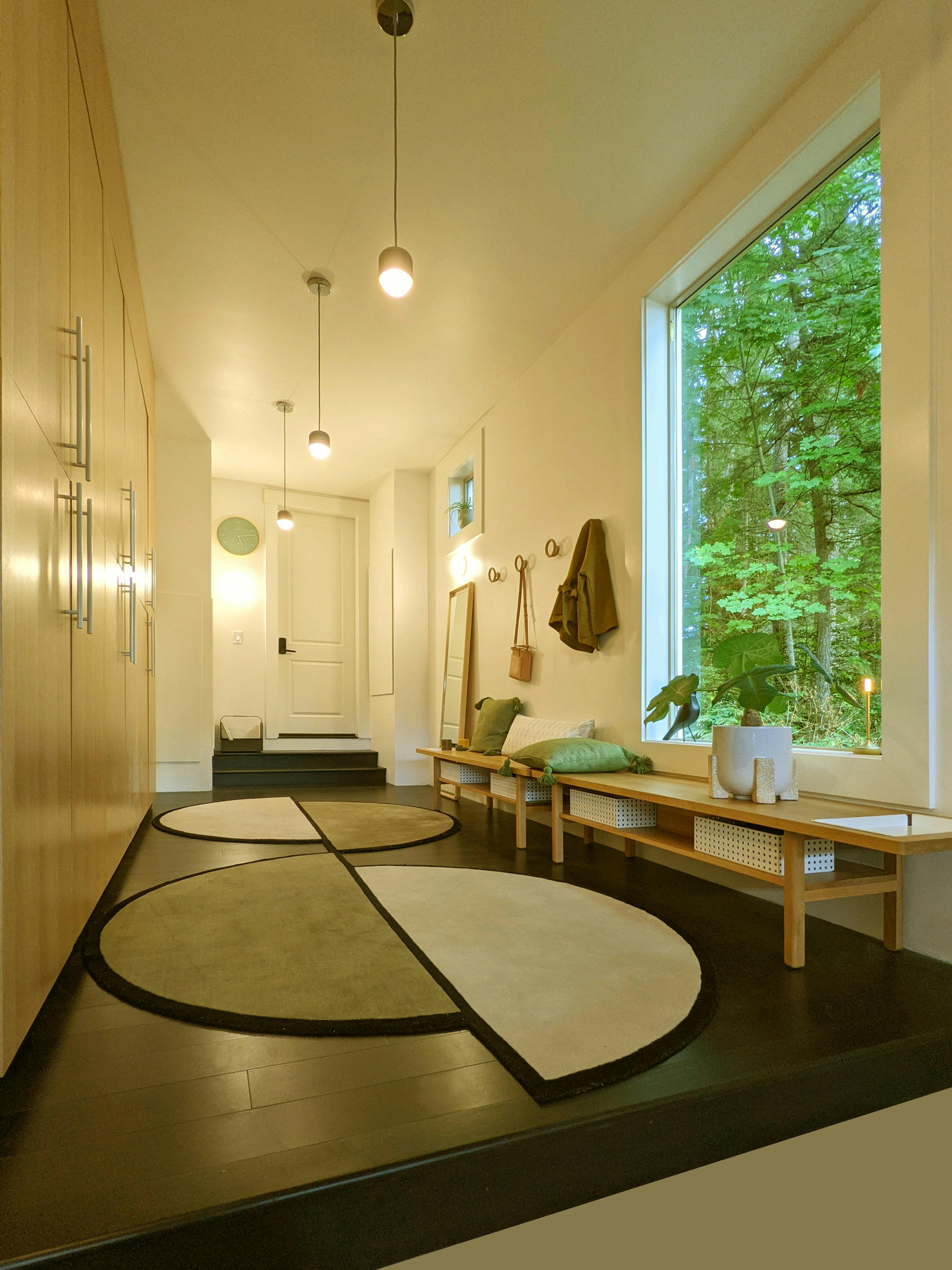 This Japandi Mud Room designed by Persimmon Design is a relaxing haven with accents of soft green. 