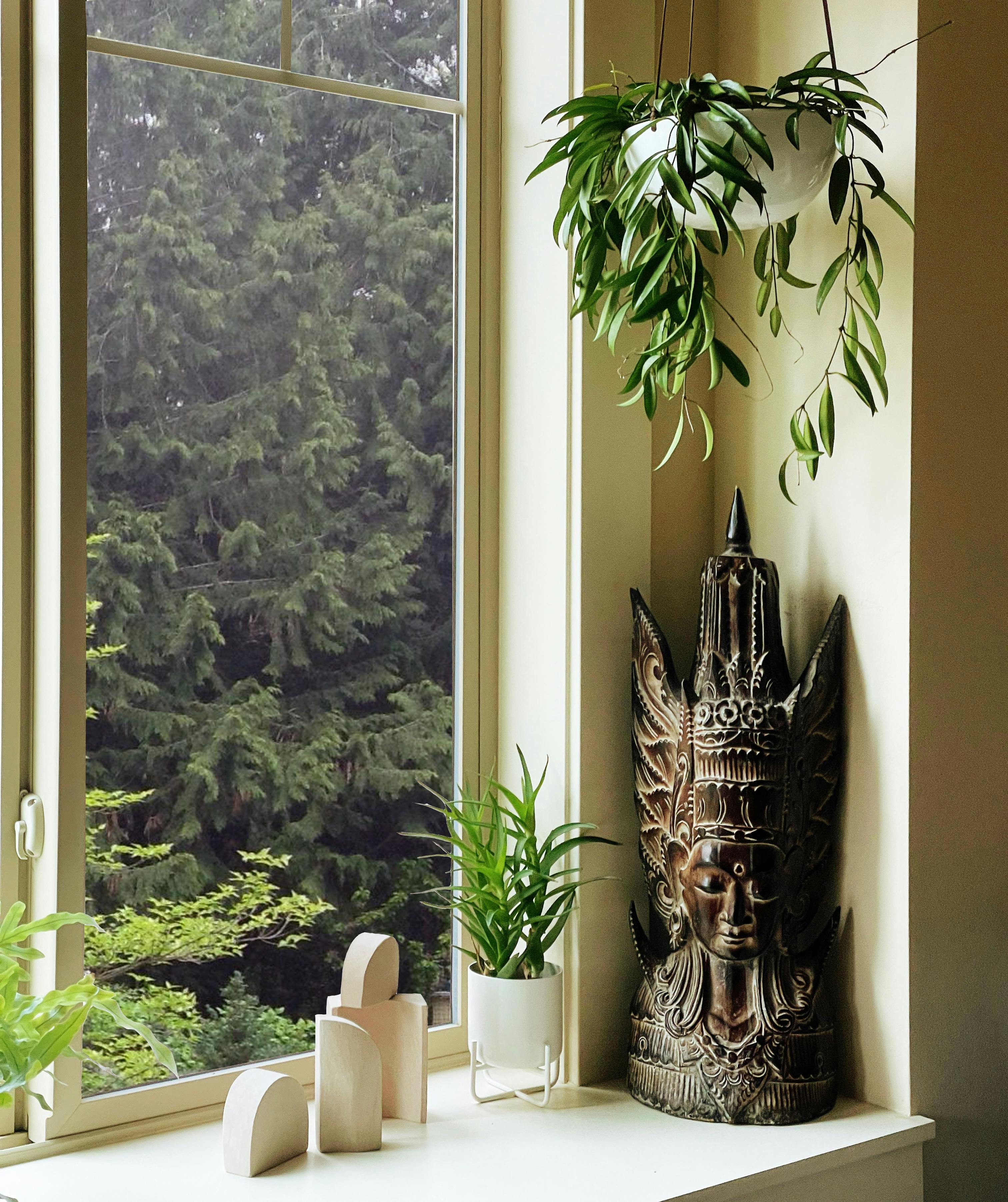 Greenery adorns a window seat designed by Persimmon Design