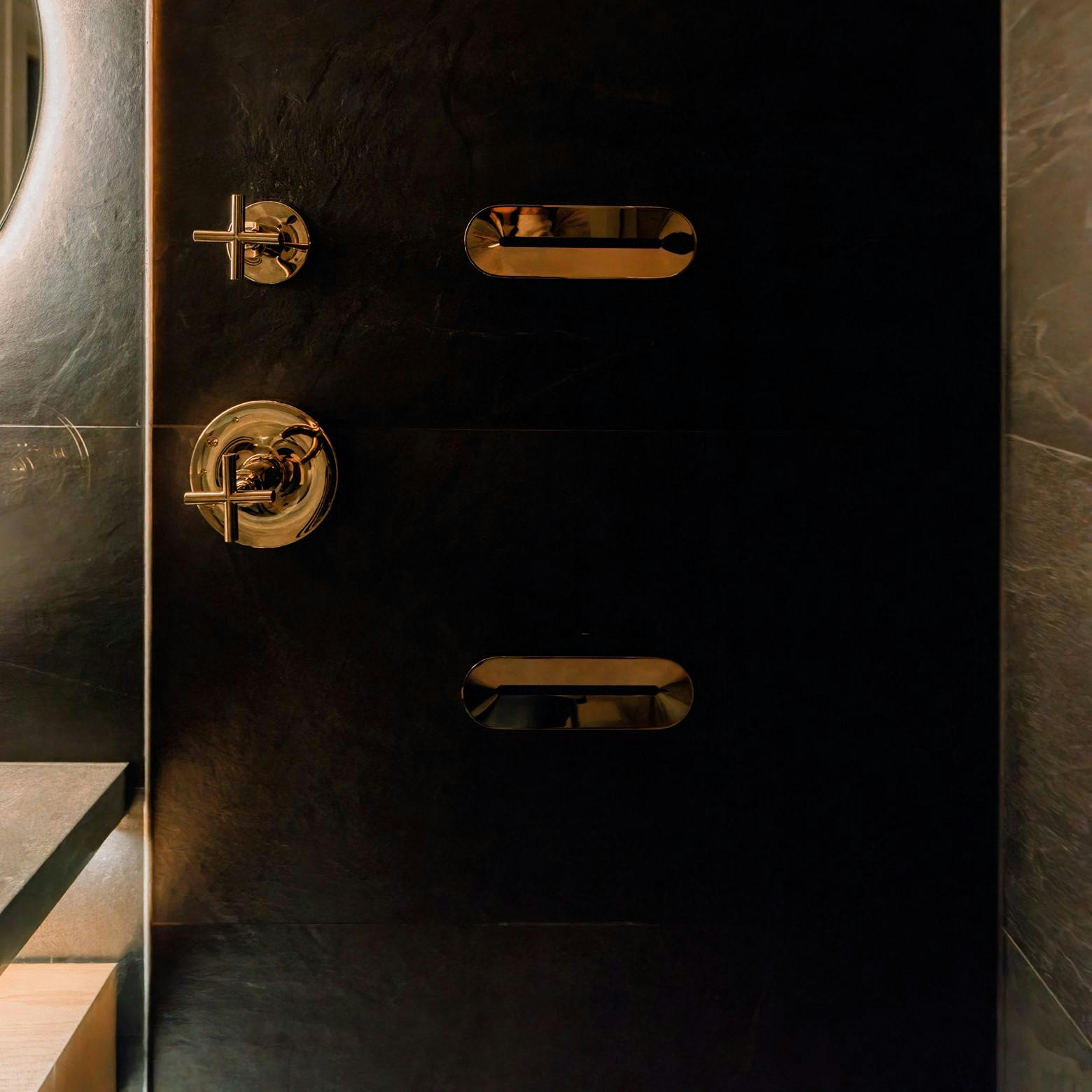 A standout feature in this bathroom is the combination of massaging body jets and a rain shower, elevating the space to a spa-level experience – Design by Persimmon Design