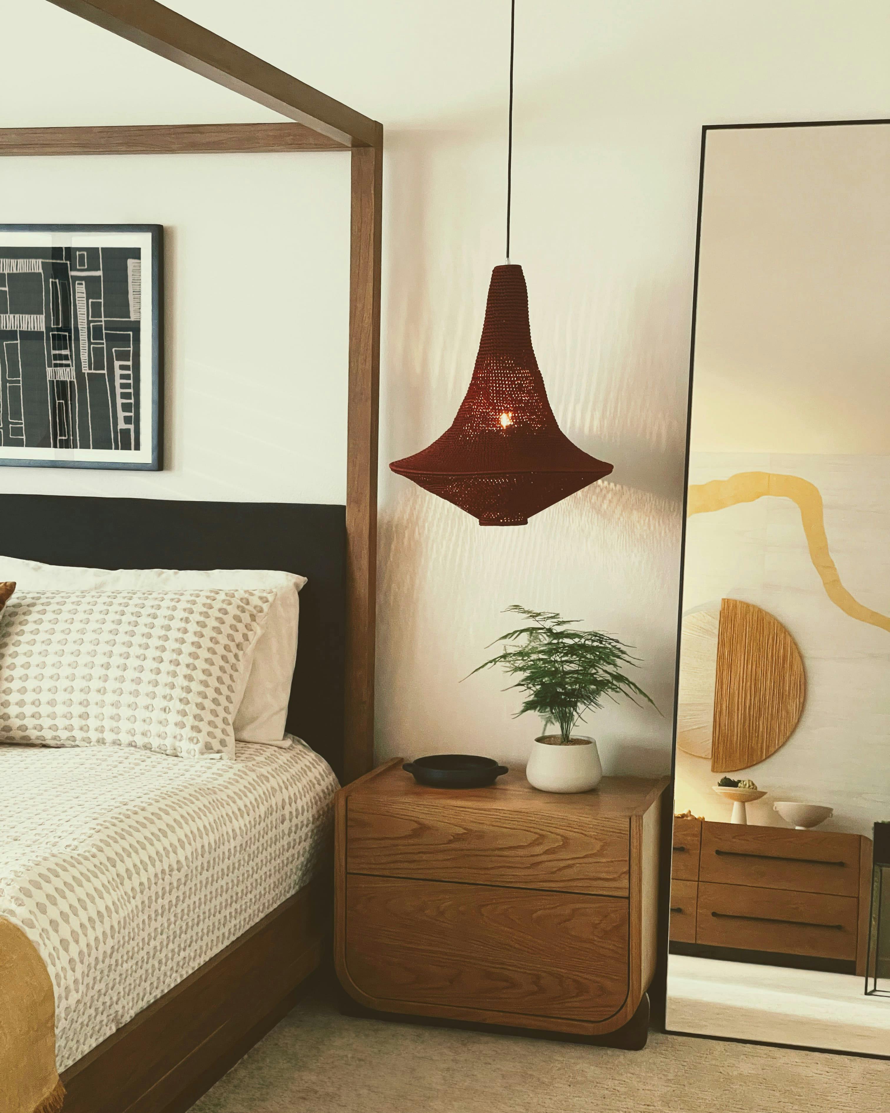 In this master bedroom by Persimmon Design, a sleek modern mirror captures the golden arc of a Kintsugi-inspired wallcovering, reflecting both its texture and the story it tells of beauty in imperfection.