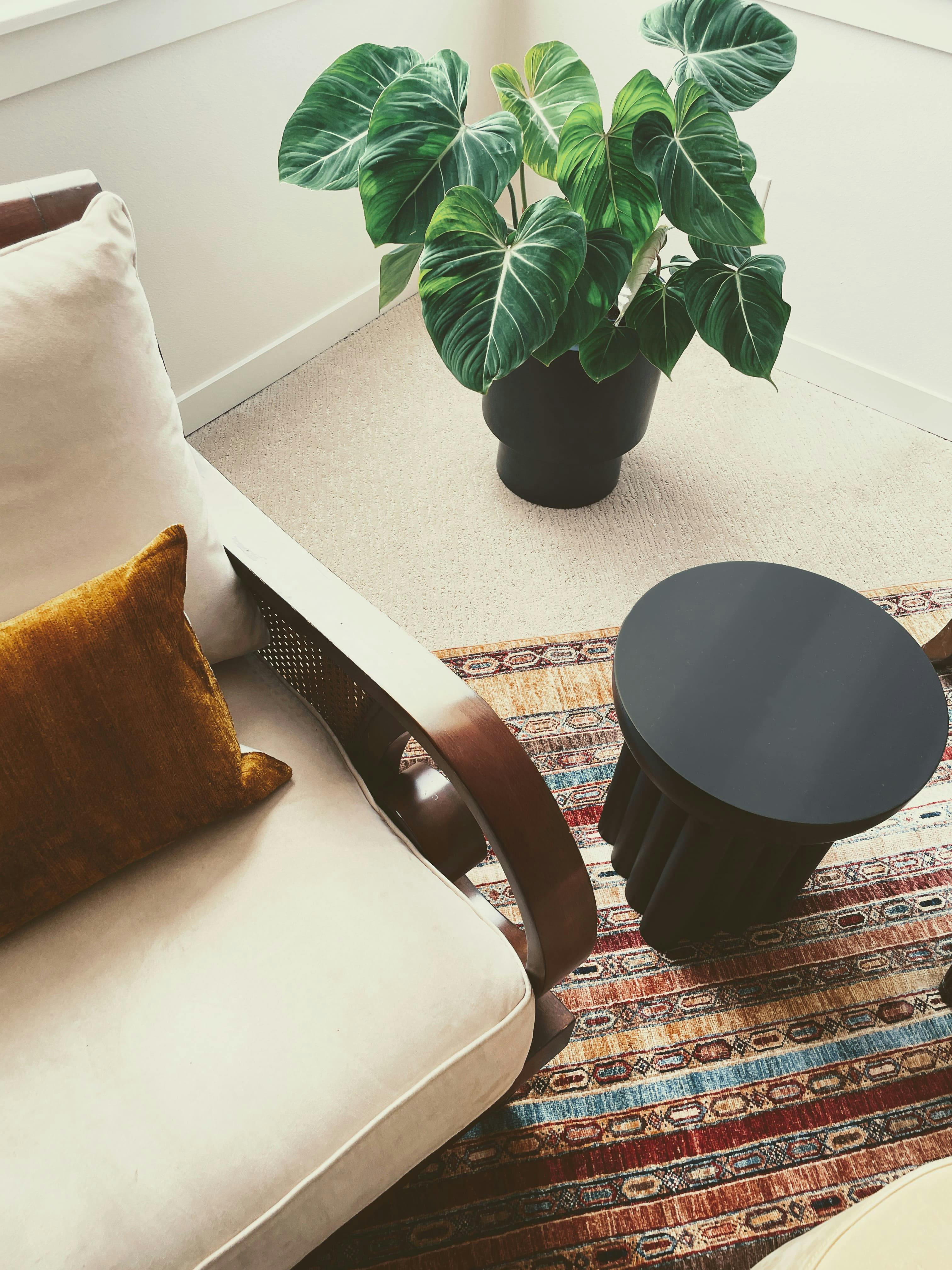 An antique Turkish rug brings layers of history to this Master Bedroom by Persimmon Design, its patina revealed in softened dyes and timeworn fibers that lend warmth, depth, and a quiet elegance to the space.
