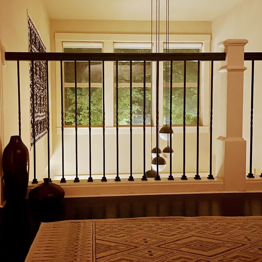 A Suzani tapestry adorns a double height space in this home designed by Persimmon Design